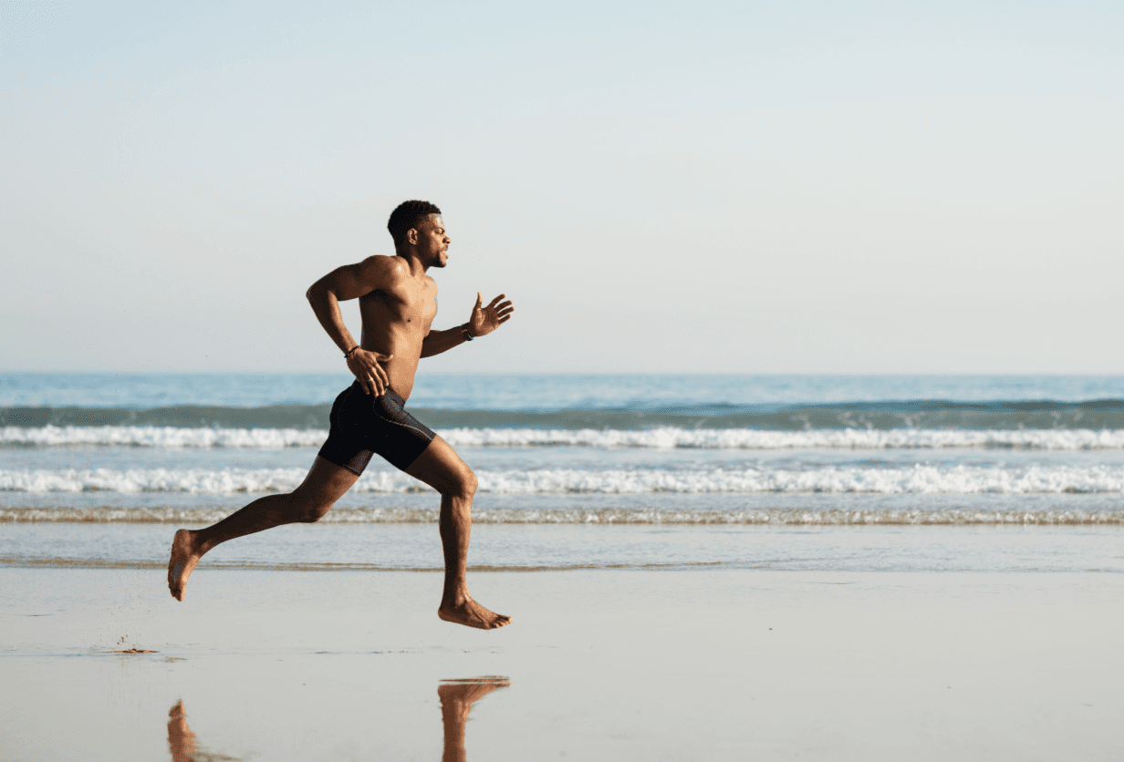 Athletic man running on the beach