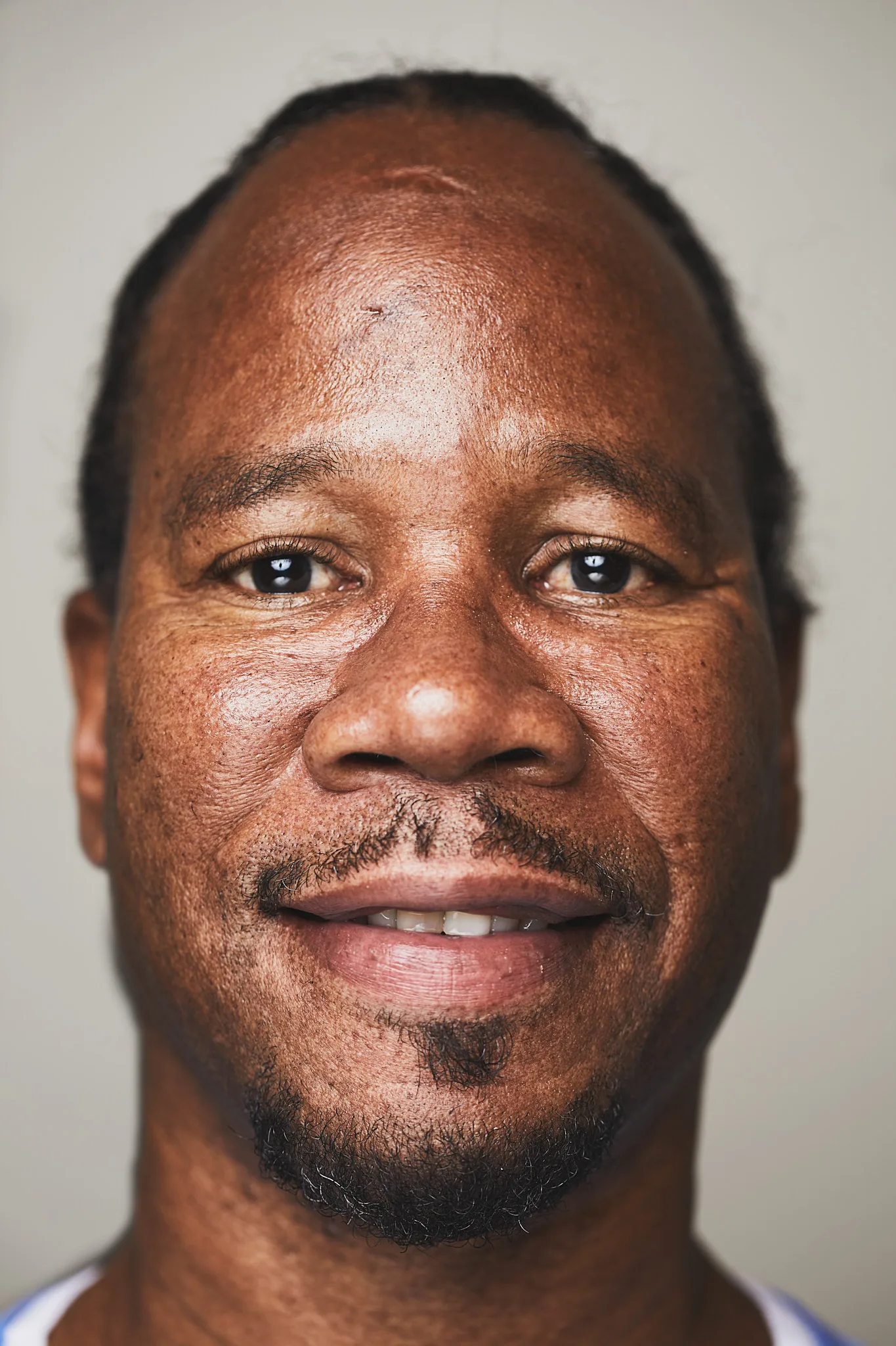 close up portrait faint smile direct gaze — portrait photography by Tom Kubik