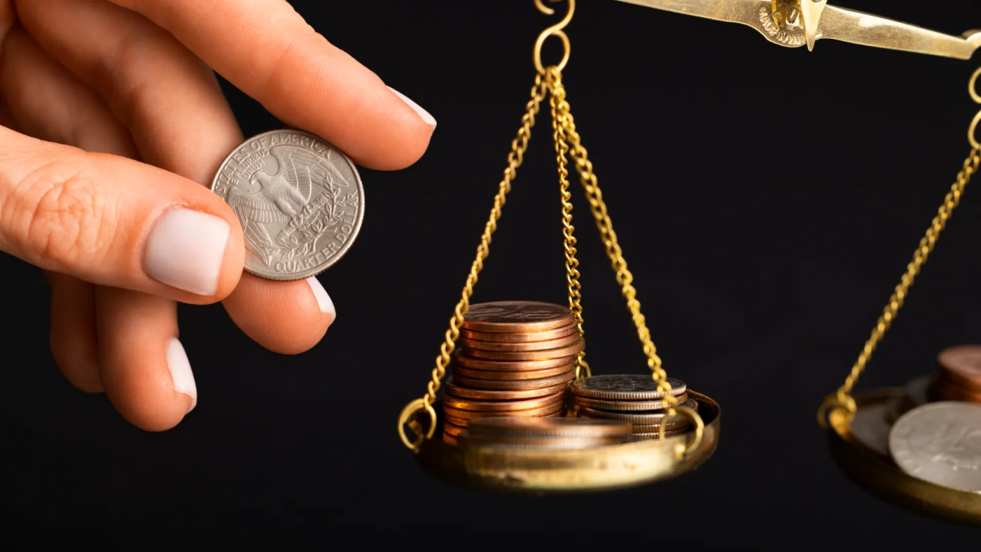 A hand balancing coins on a scale, symbolizing the financial risk of TikTok Shop IP violations and withheld payouts.