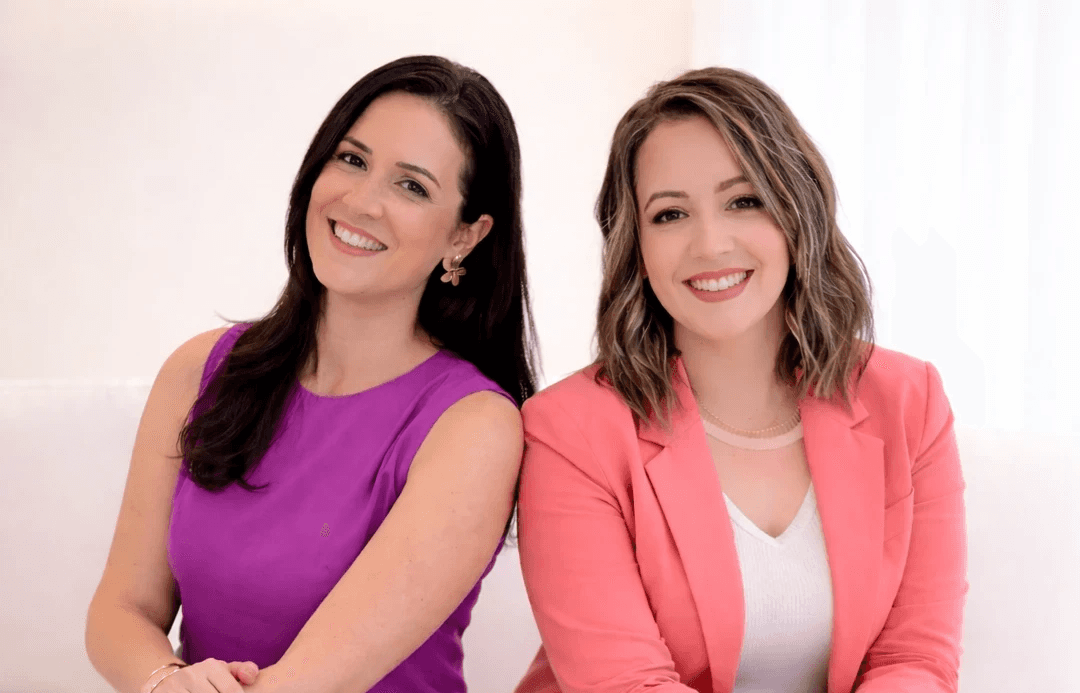 woman sitting while working on laptop and smiling 
