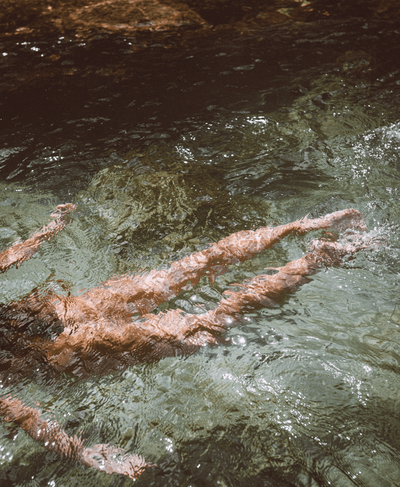 Someone swimming in clear waters