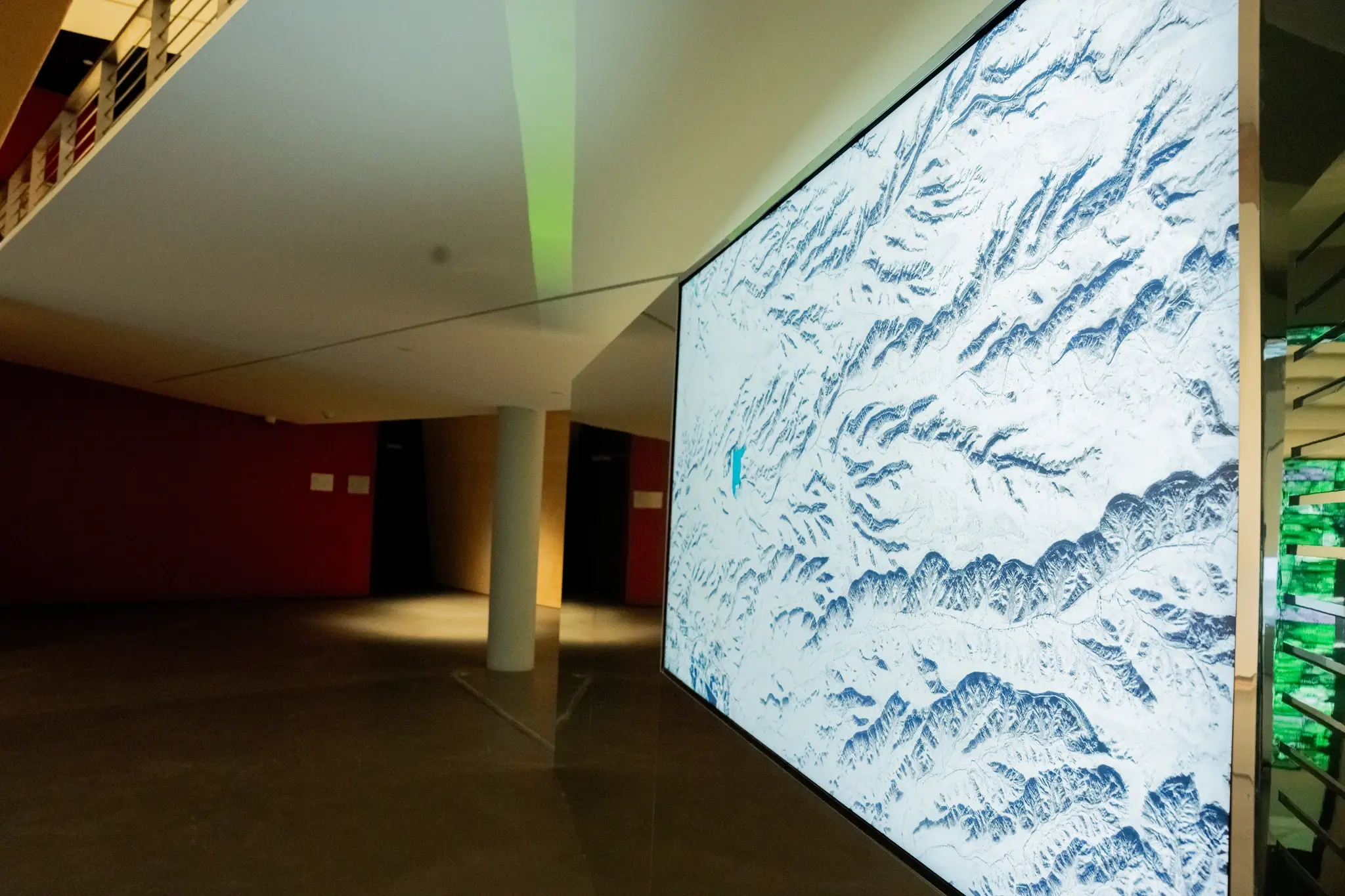 Large screen displays snow-covered mountains