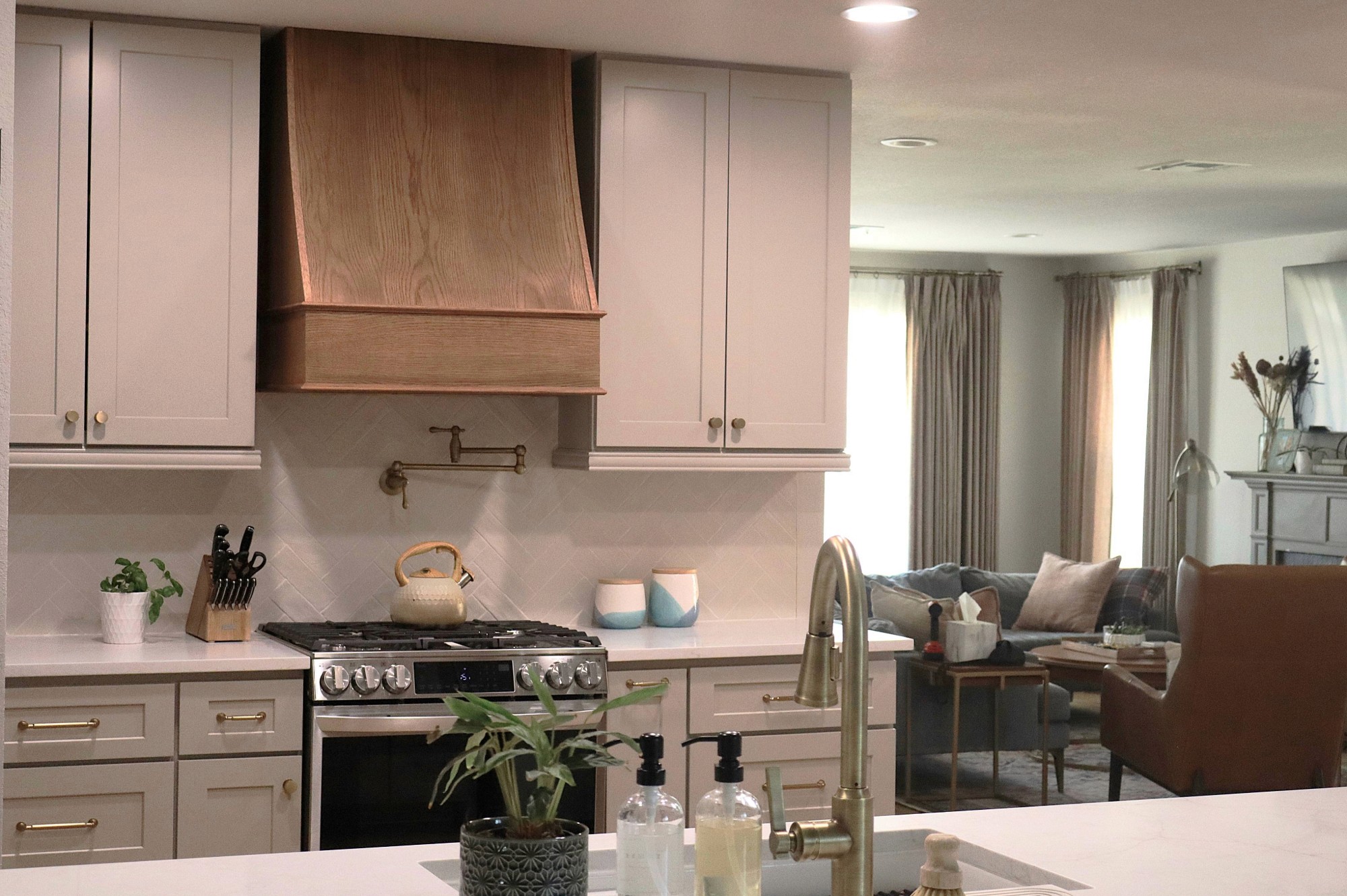 Custom dark wood cabinetry with integrated LED lighting by QW Kitchen & Bath
