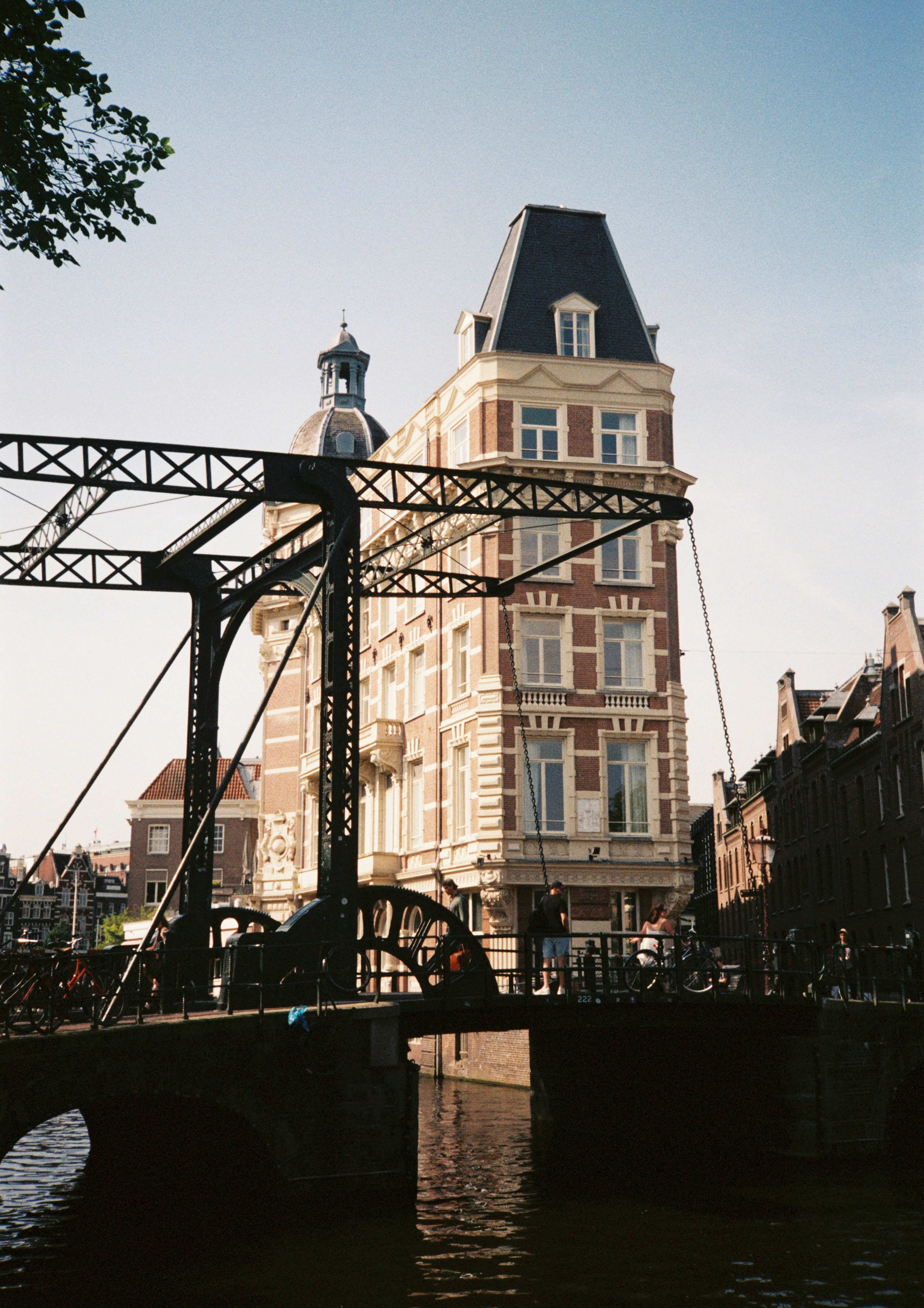 Female scientist wearing a white coat and gloves examines a sample slide in a modern laboratory setting.