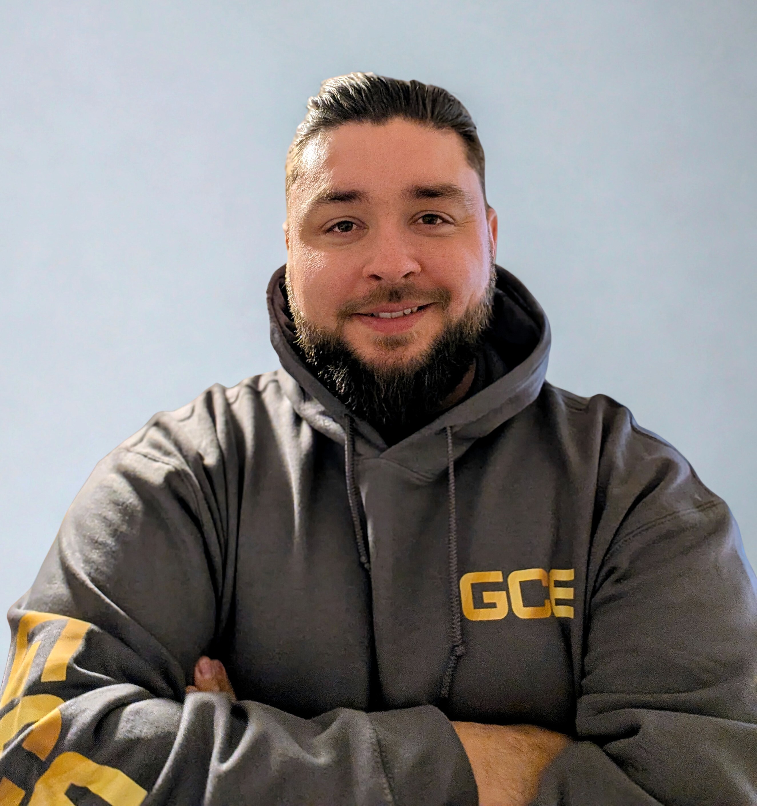 Worker pressure washing a surface outdoors