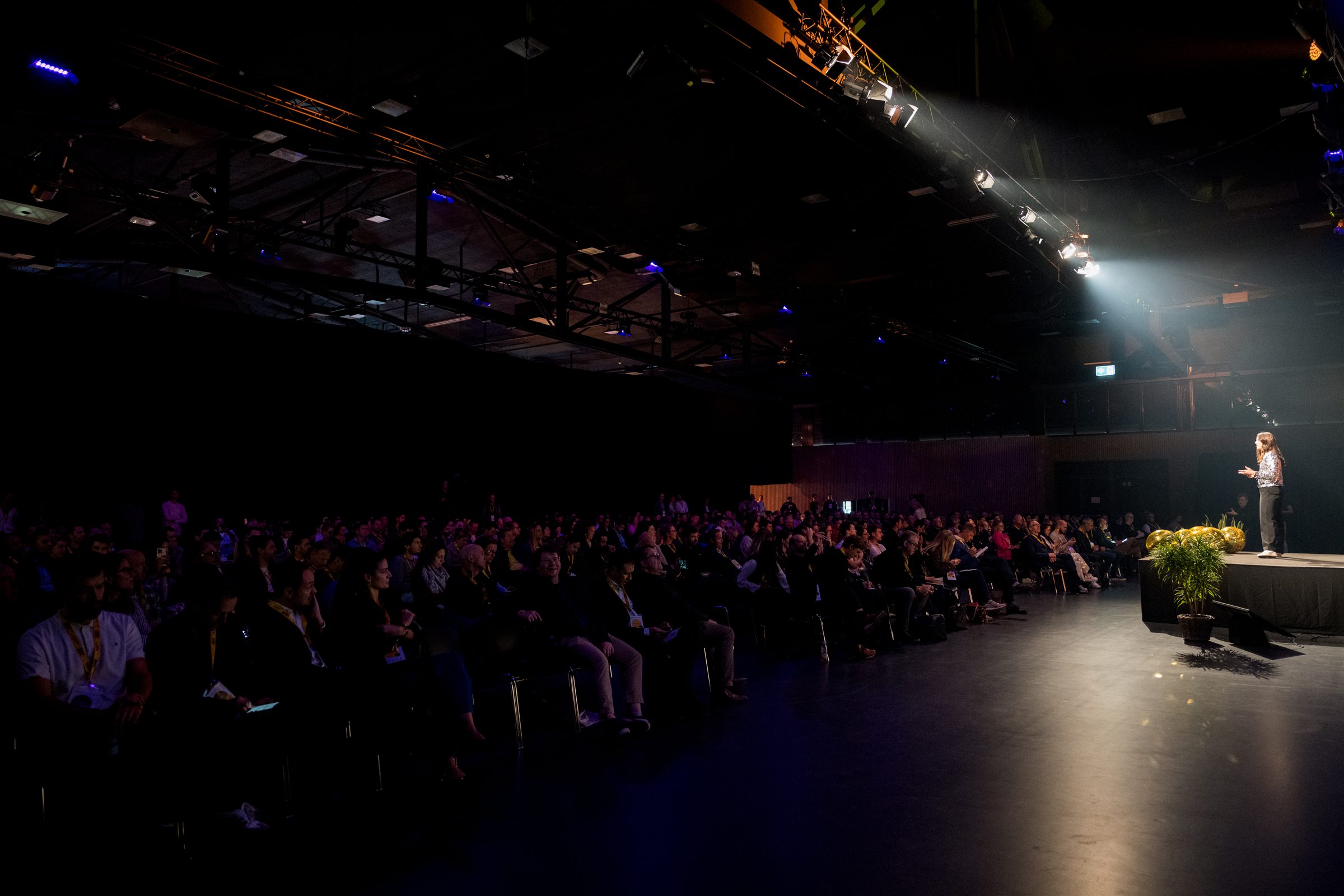 Shannon Jenkins speaking to a full conference hall
