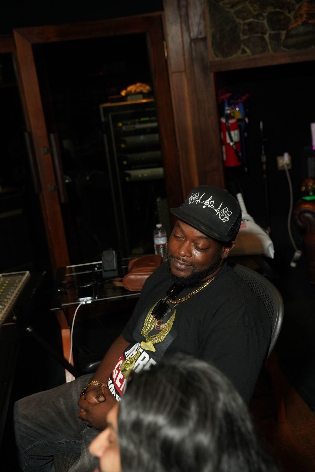 Rimanist seated at the studio mixing desk