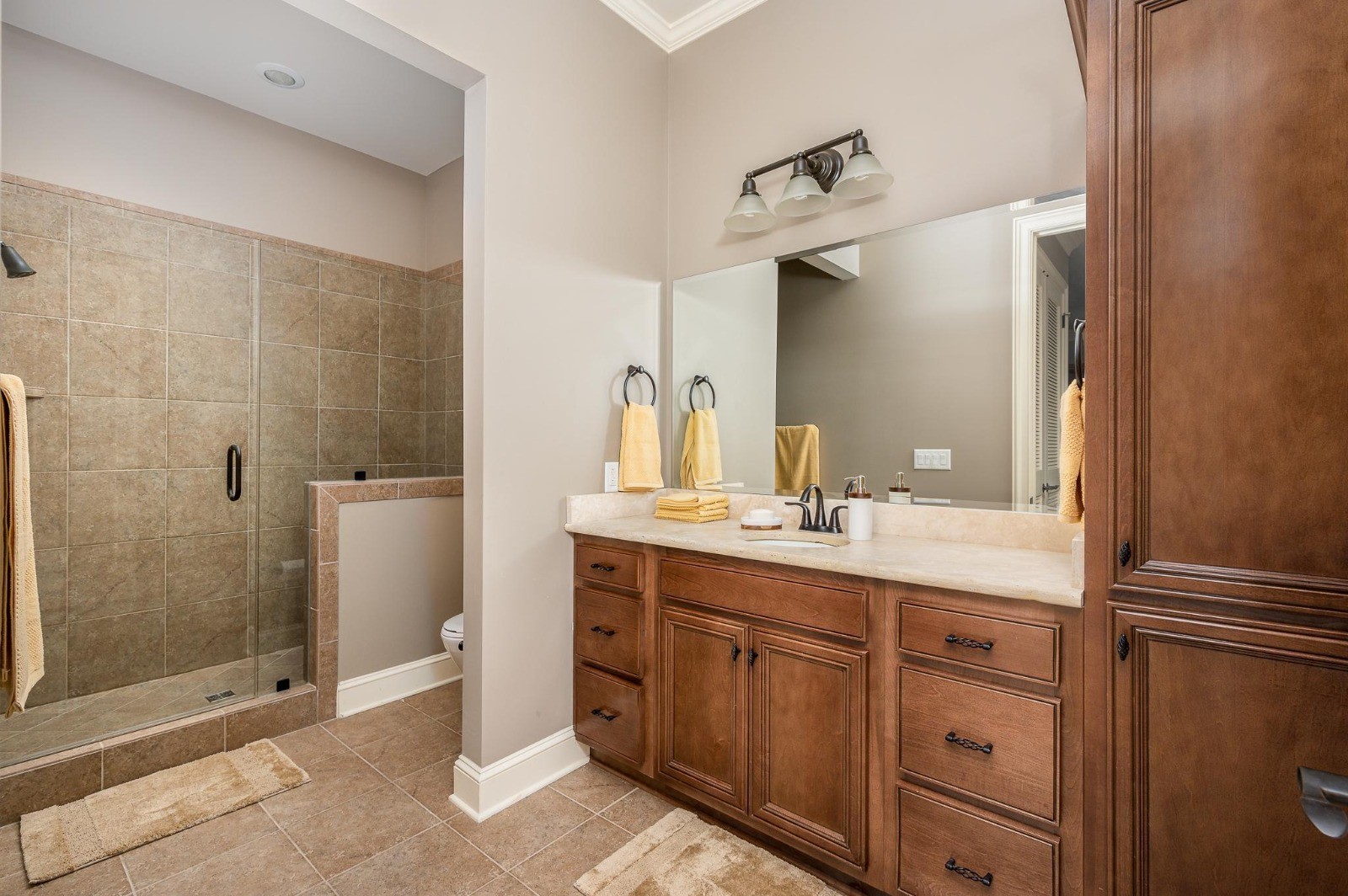 Spacious bathroom at The Gateway Village with a large, accessible walk-in shower for safe, comfortable, and easy living.