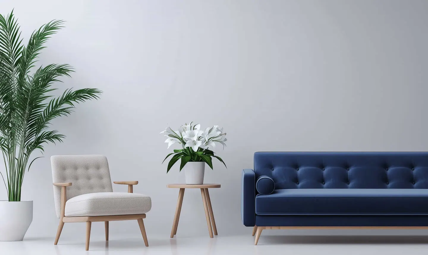 Minimalist living room with a light beige chair, blue tufted sofa, wooden side table, potted flowers, and a large green pl