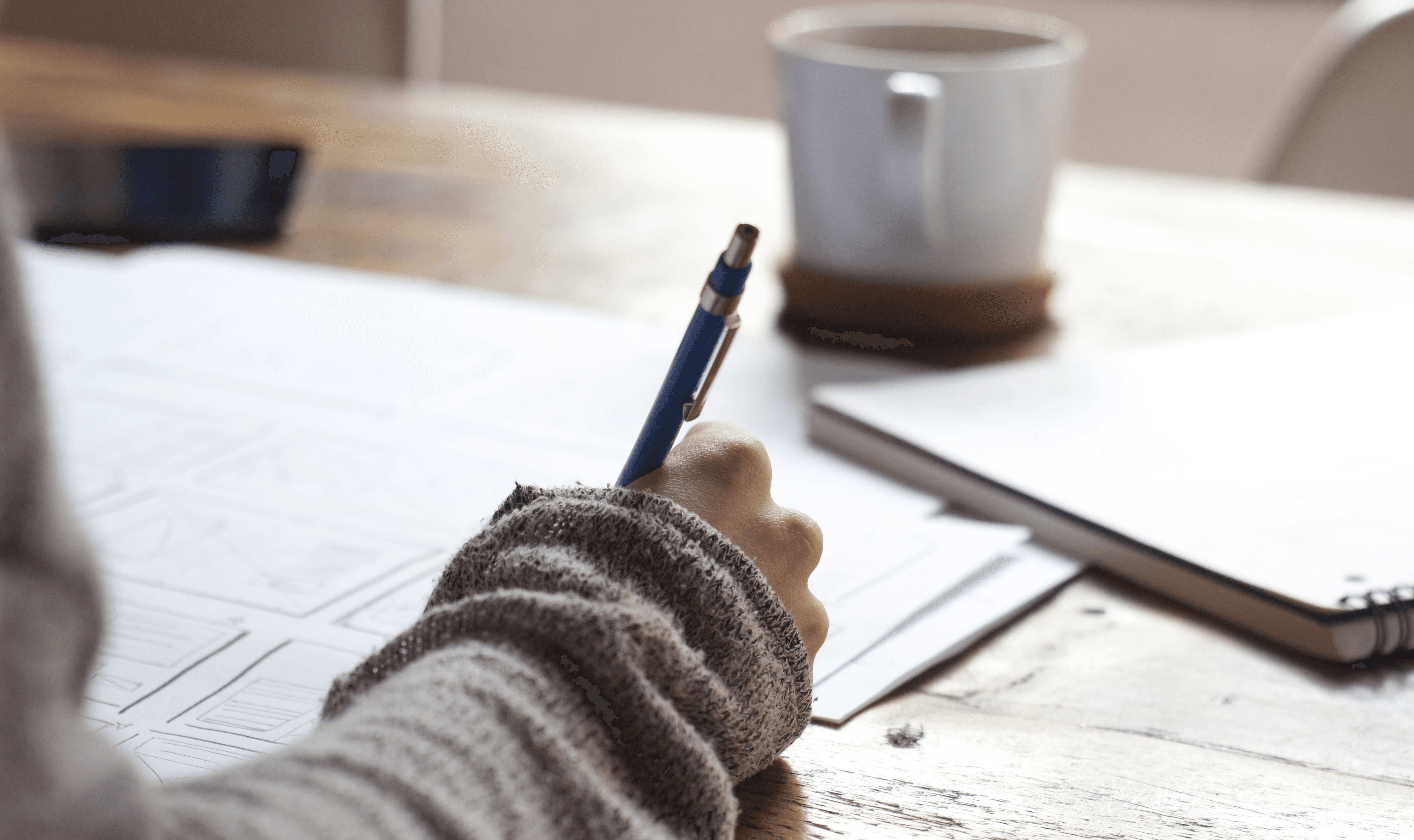 Handwritten notes next to coffee - How To Write A Video Summary