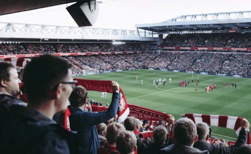 Soccer Fans Analyzing their betting strategies at the game.