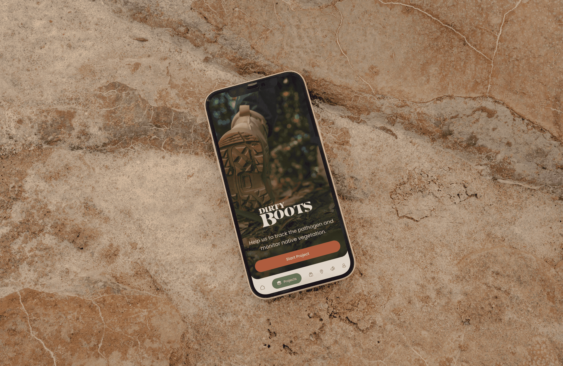 A mock-up of the app shown in a phone lying on a rock outdoors.