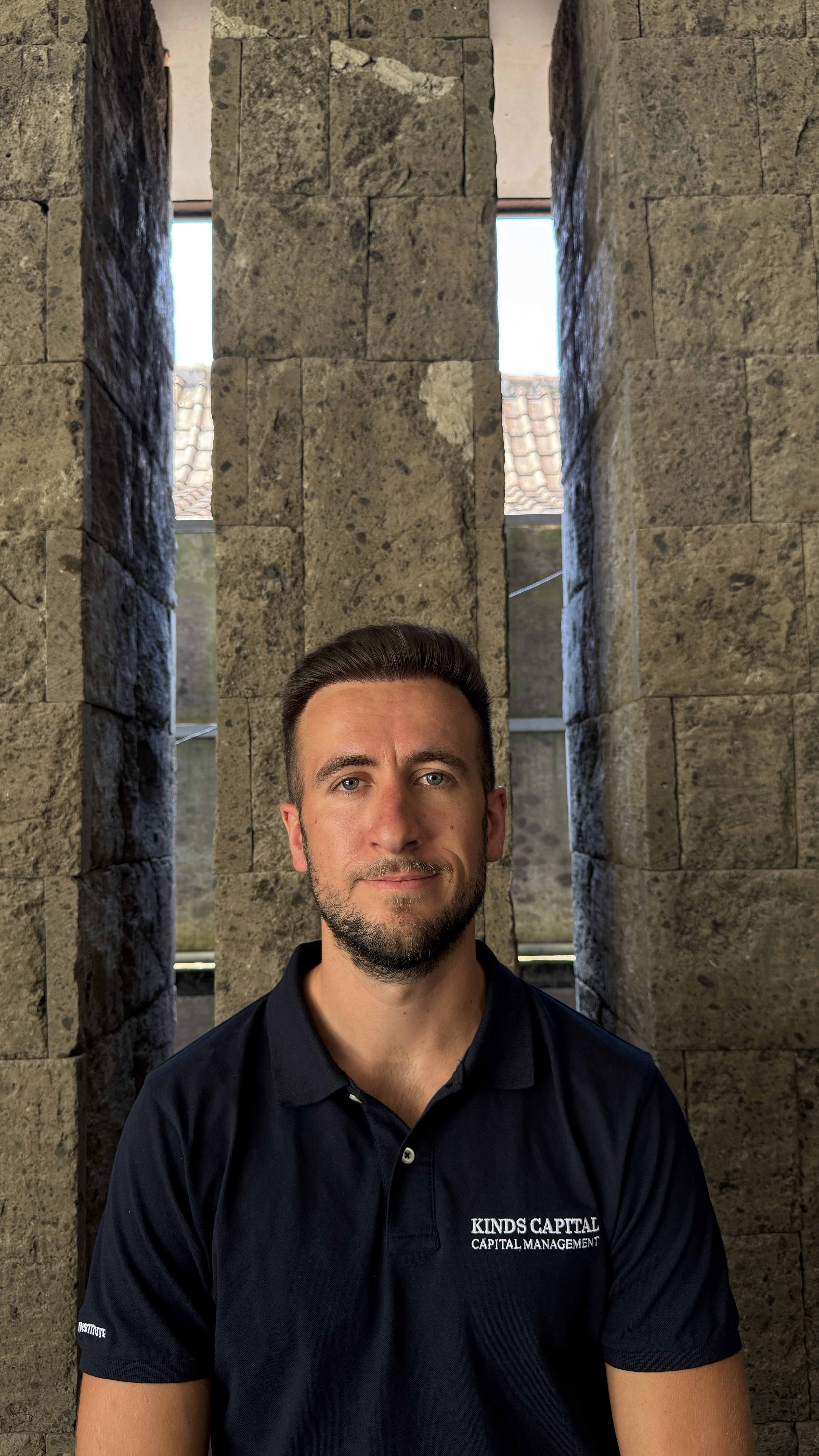 a gazebo sitting on top of a lush green hillside next to a lake