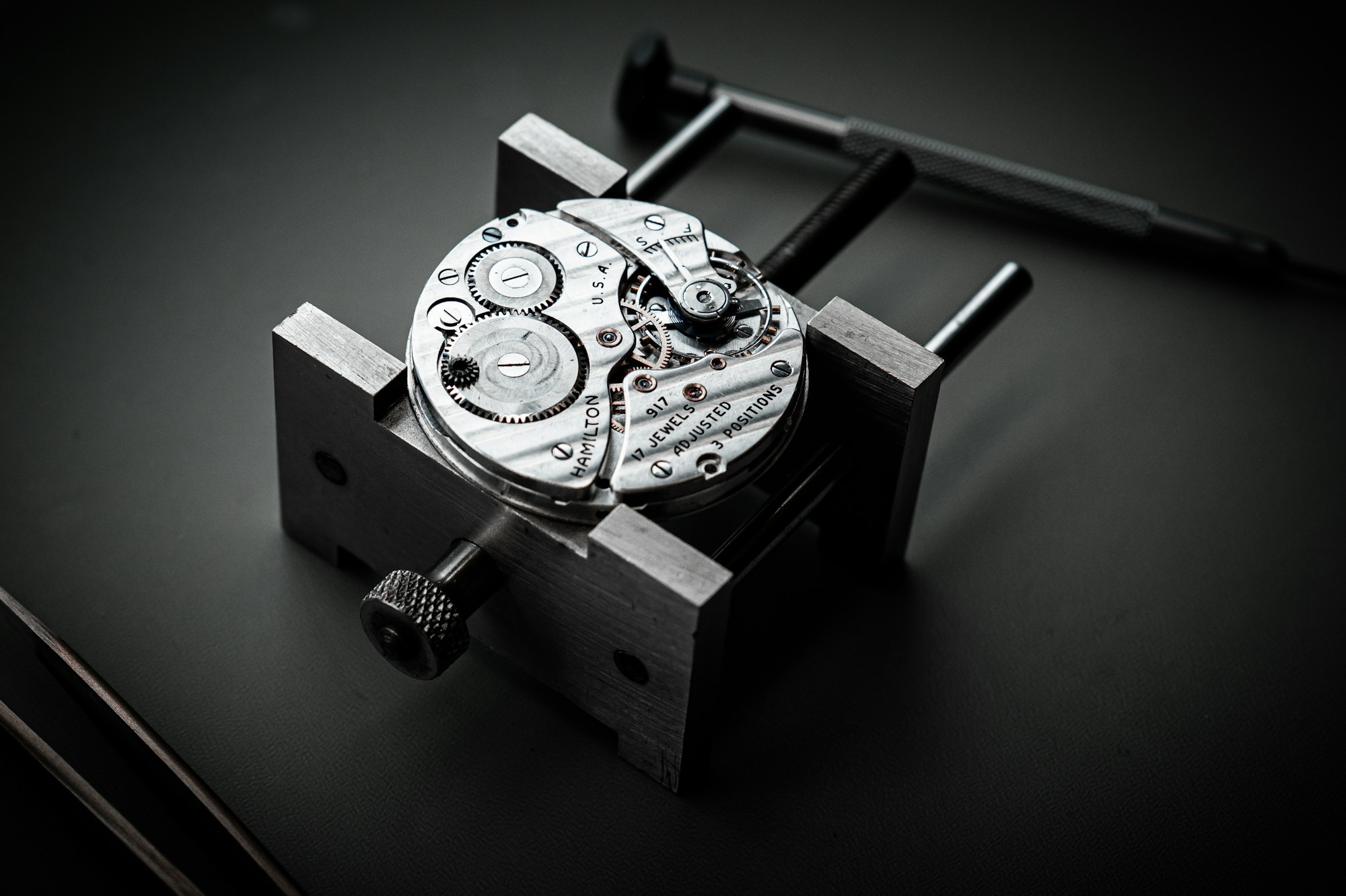 Watch movement secured in a holder for inspection