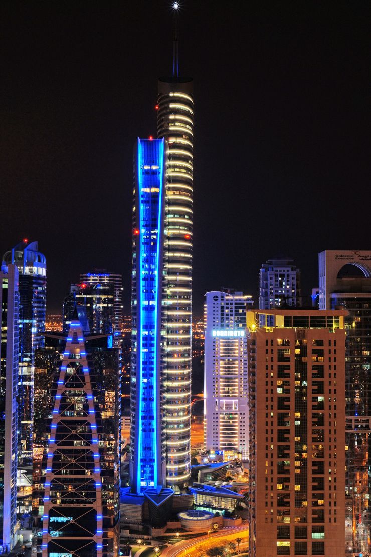 Vibrant night view of Almas Towers Dubai skyline, perfect for high-end real estate ventures.