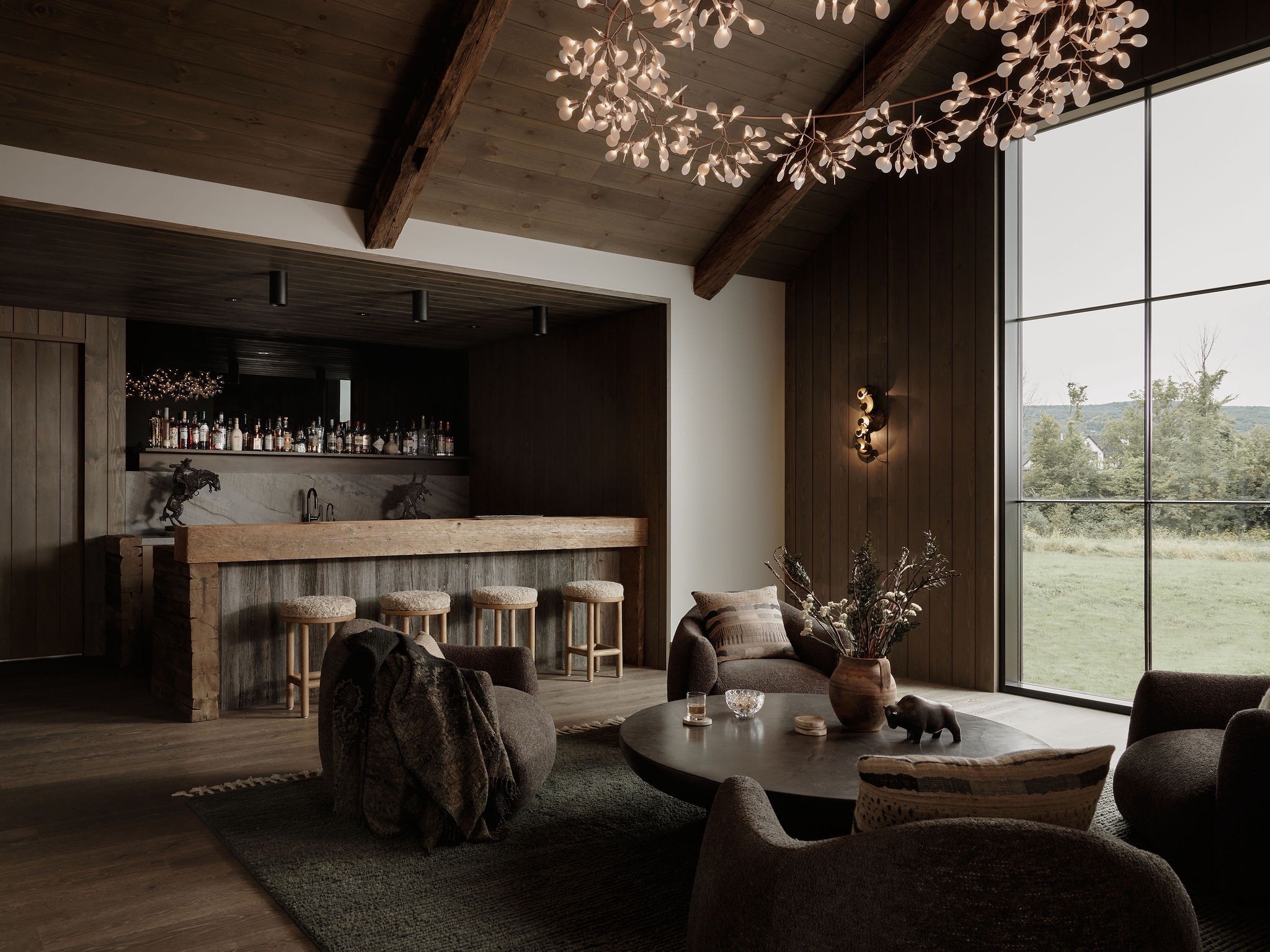 The bar and lounge, with stools along a timber counter