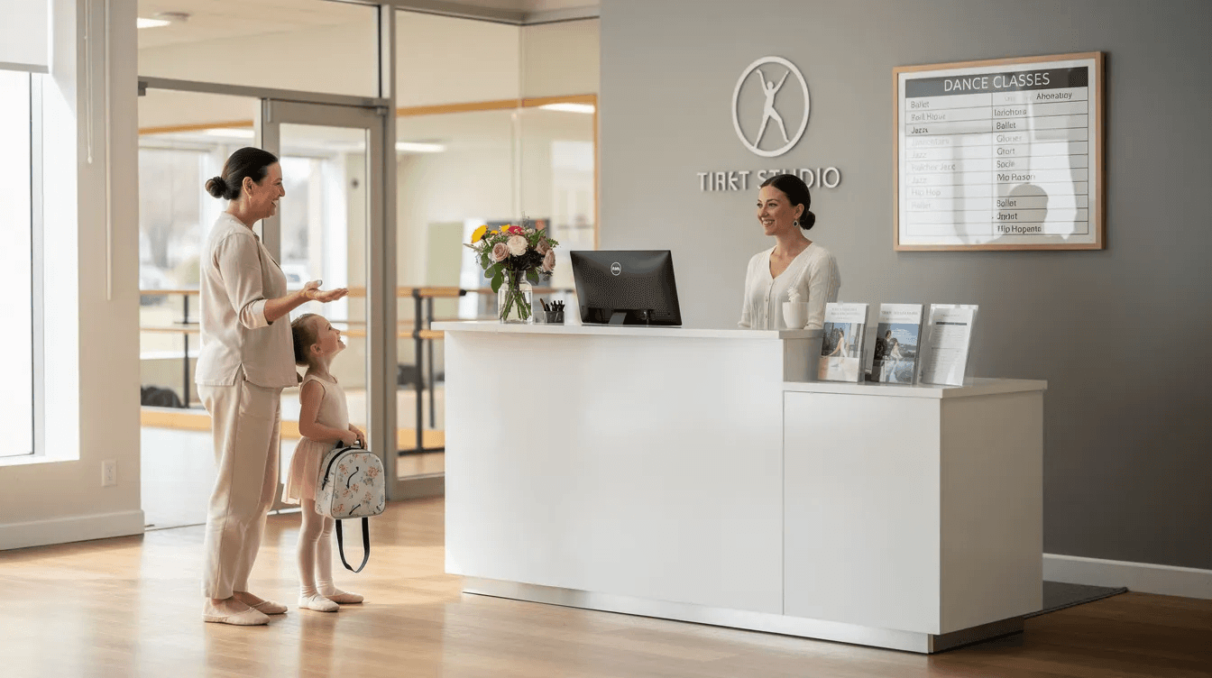 A parent and child are smiling and engaging in conversation with a receptionist at the front desk of a dance studio, creating a welcoming atmosphere for new students. The scene highlights the importance of communication and student engagement in the dance studio environment.