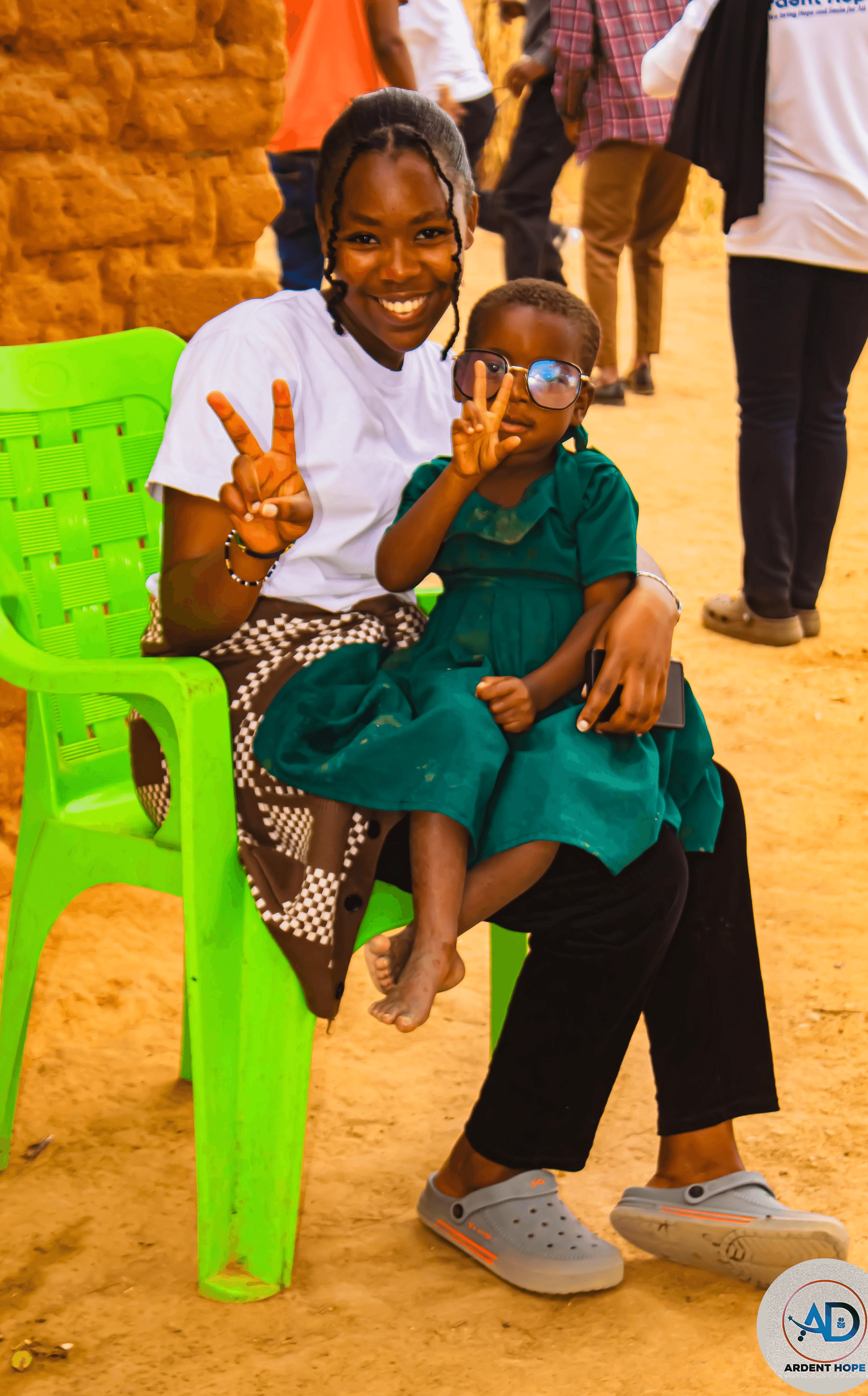 five children smiling while doing peace hand sign