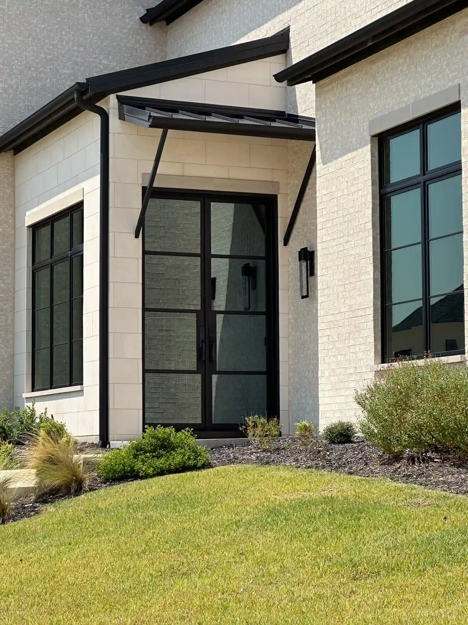 Modern architectural low profile iron double doors on a Southlake home