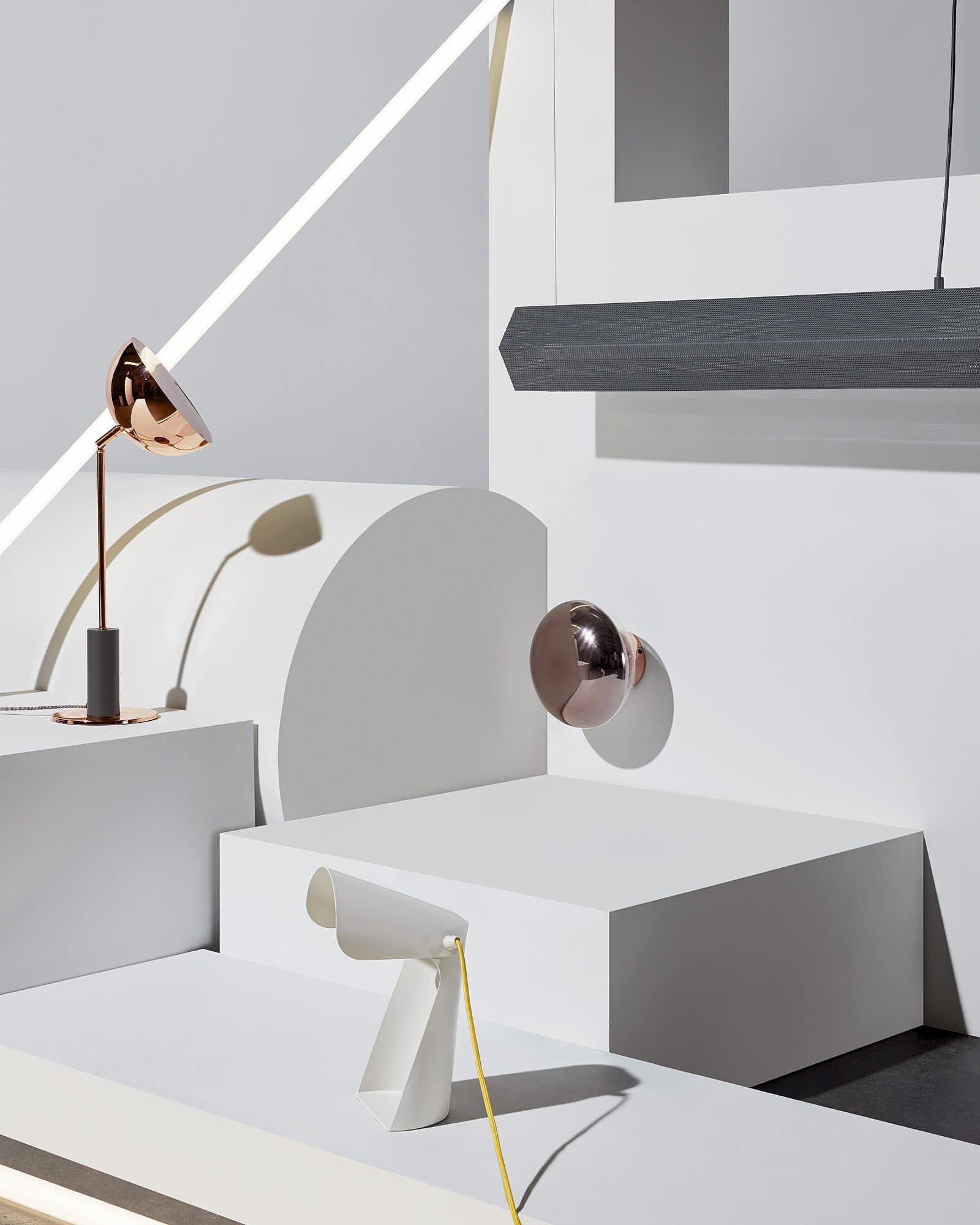 Modern geometric interior design with contemporary lighting fixtures and minimalist white decor.