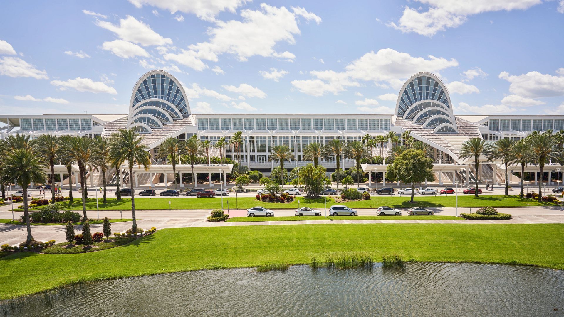 Orlando sports and outdoor trade show booth with equipment displays, apparel, product shelves, meeting space, and open buyer access