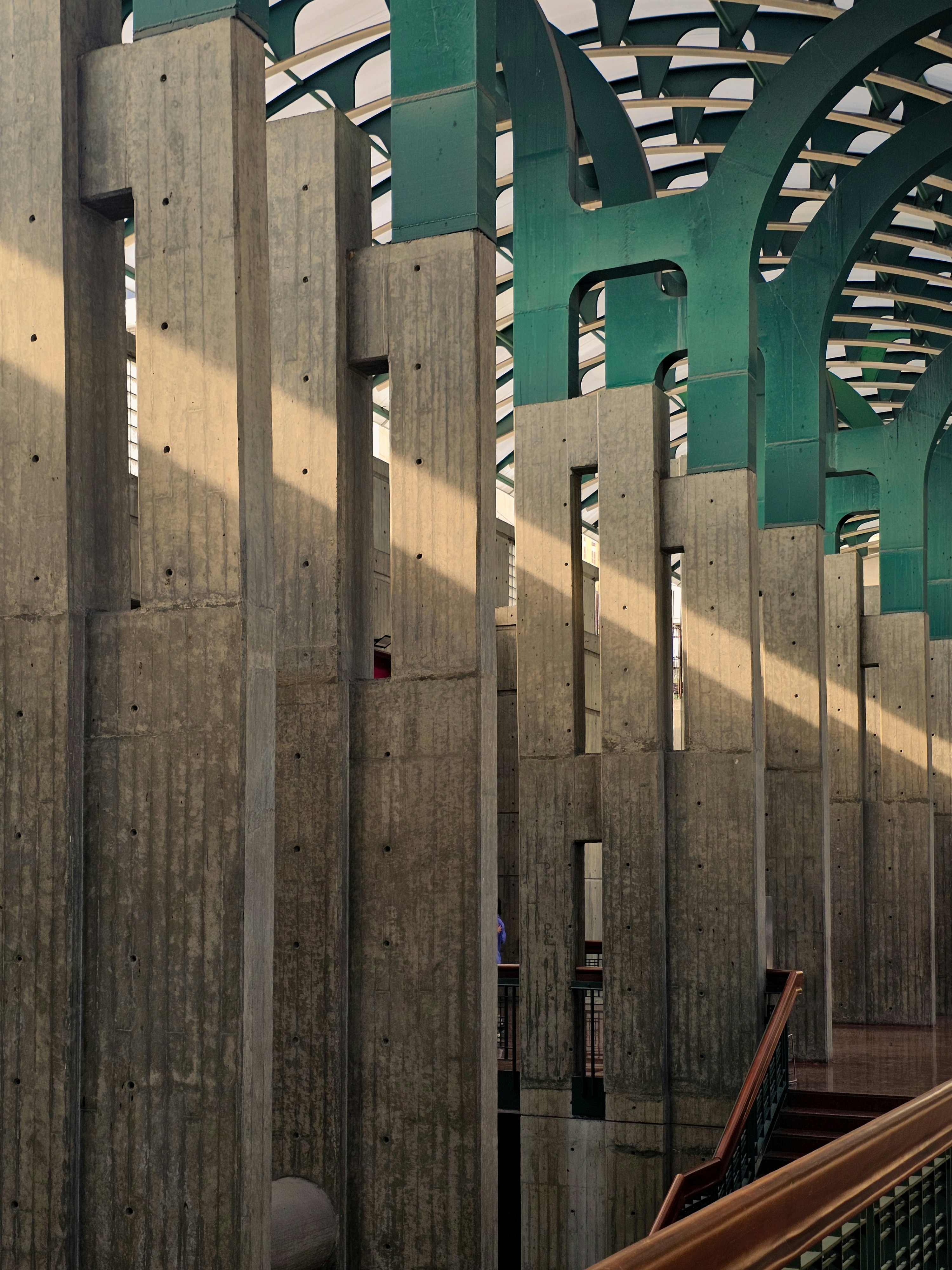 Concrete pillars with green arched ceiling structure