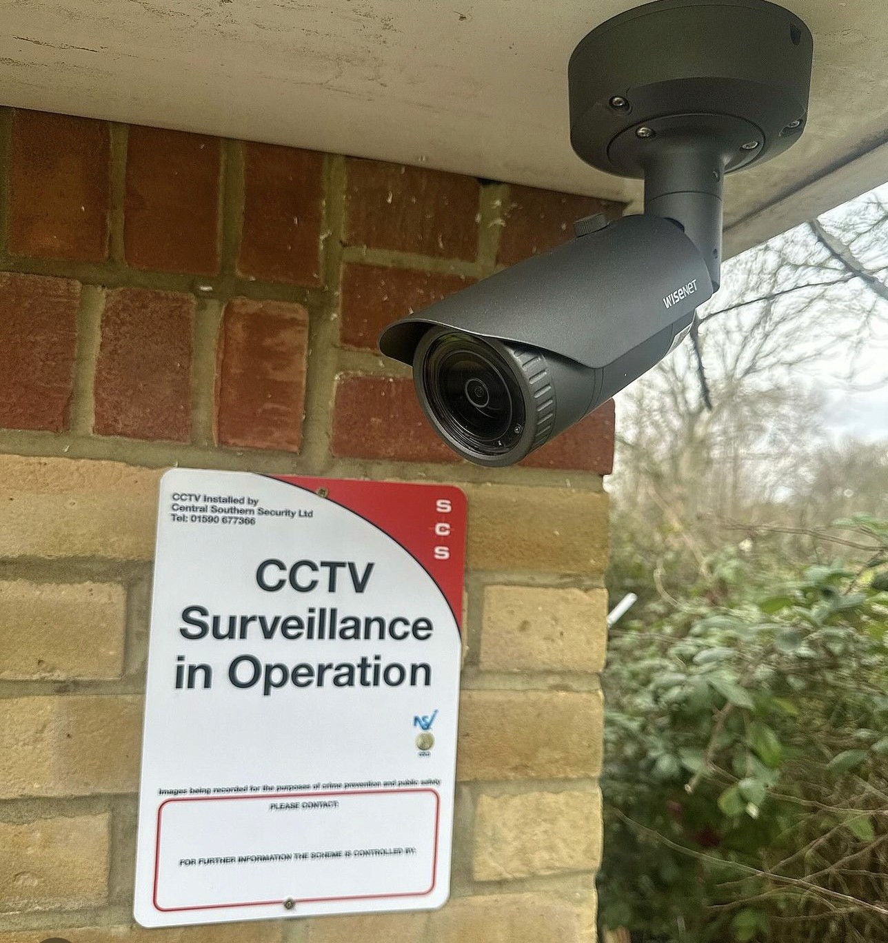 white and black camera on tripod