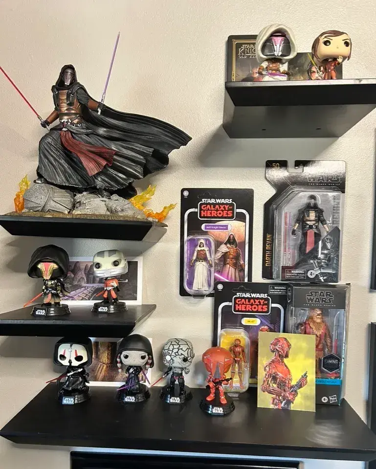 A shelf packed with Jared’s personal Knights of the Old Republic collection, featuring an array of action figures, Funko Pops, and memorabilia dedicated to Darth Revan and other KOTOR characters.