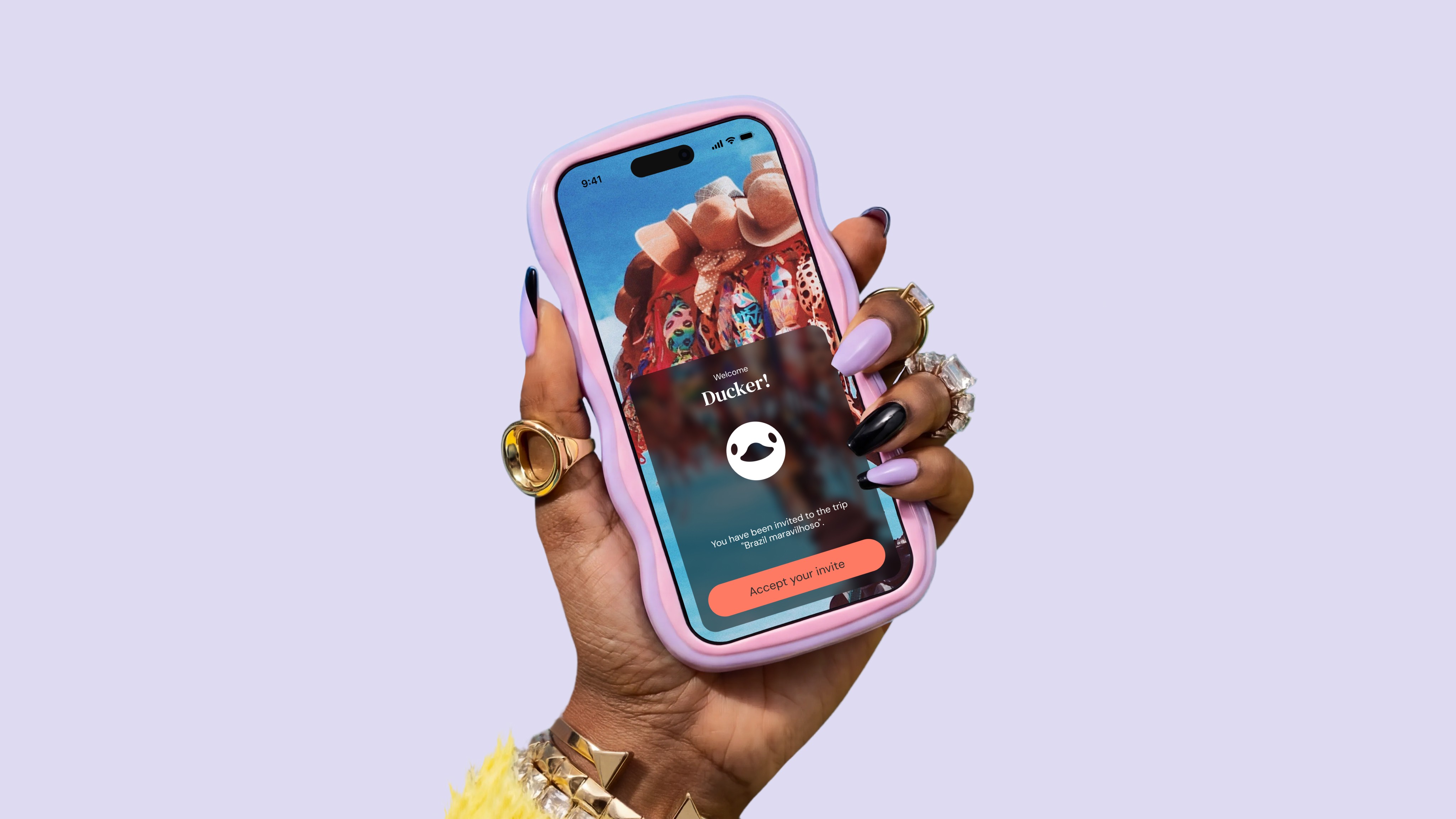 A hand with lilac and black manicured nails holding a smartphone in a wavy pink case. The screen displays a "Welcome Ducker!" invite from DuckAround notification over a travel-themed background.