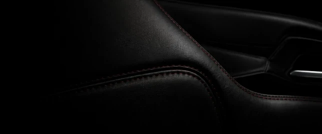 Black automotive leather with red stitching