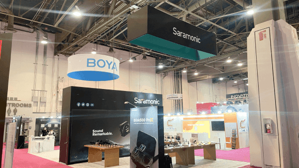 Saramonic BOYA NAB Show booth with audio product displays, branded presentation walls, hanging signage, and visitor-facing demo counters