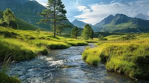 A smiling young man with crossed arms, wearing a plaid shirt and white t-shirt, poses against a dark background.