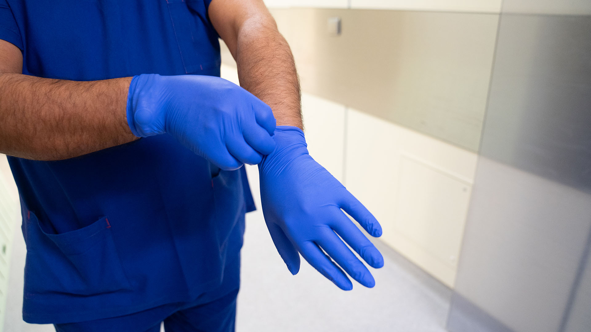 Close-up of cleaning member wearing personal protective equipment