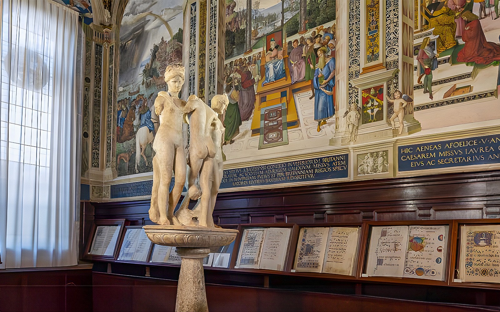 Sculpture and frescoes inside Siena Cathedral library, Italy.
