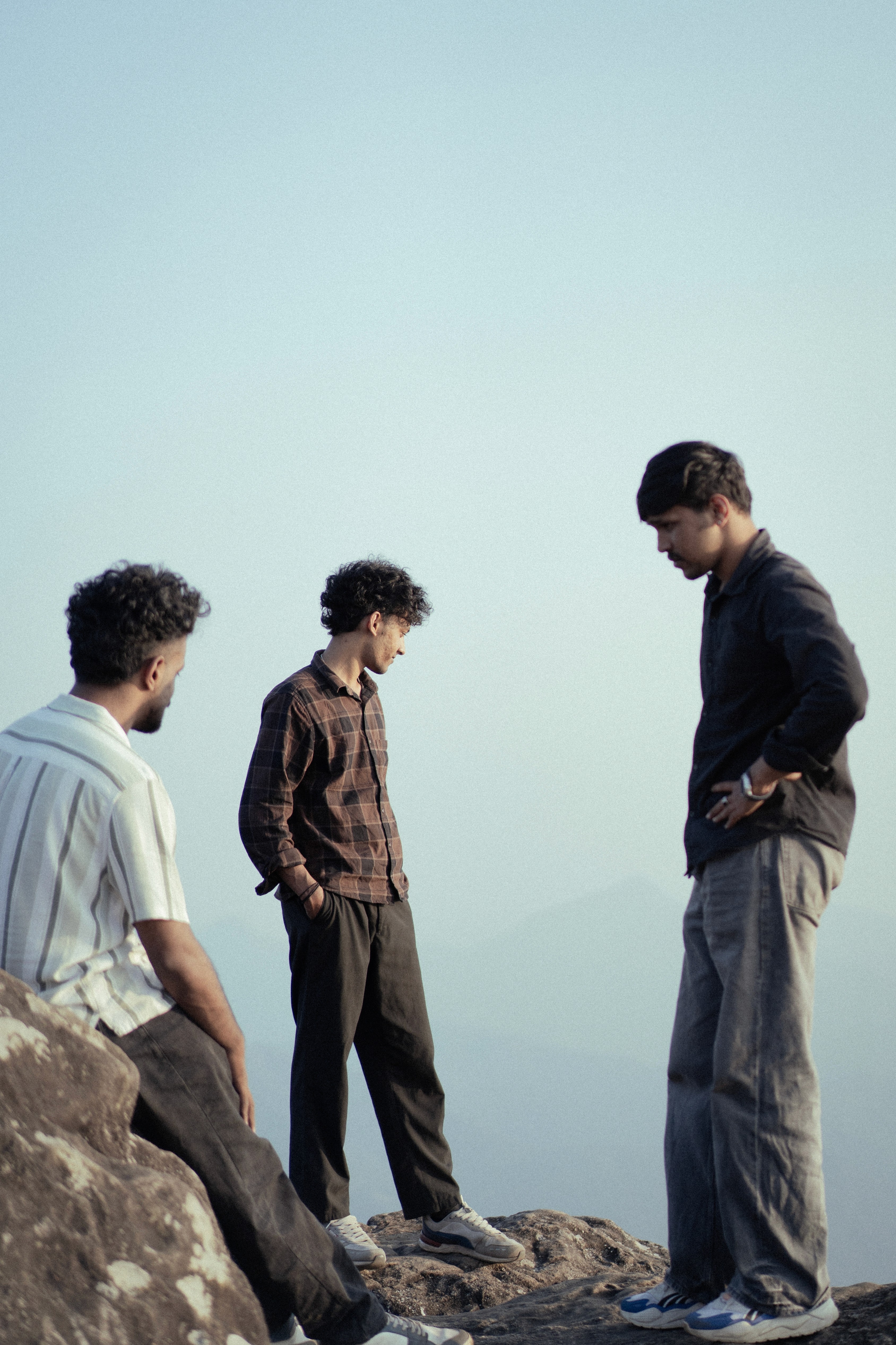 Two friends on a rocky outcrop against a hazy sky
