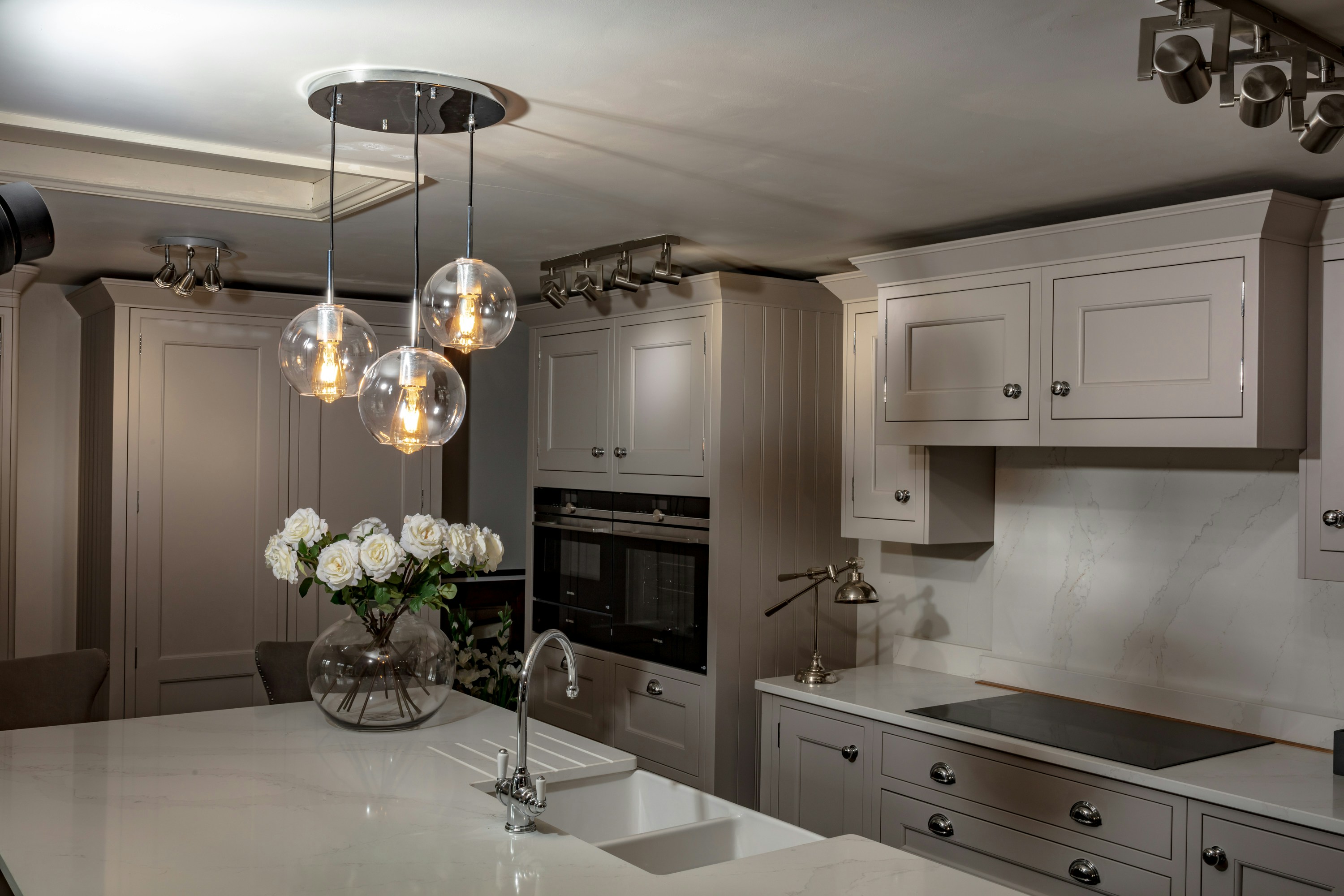 A large kitchen with a center island and a chandelier