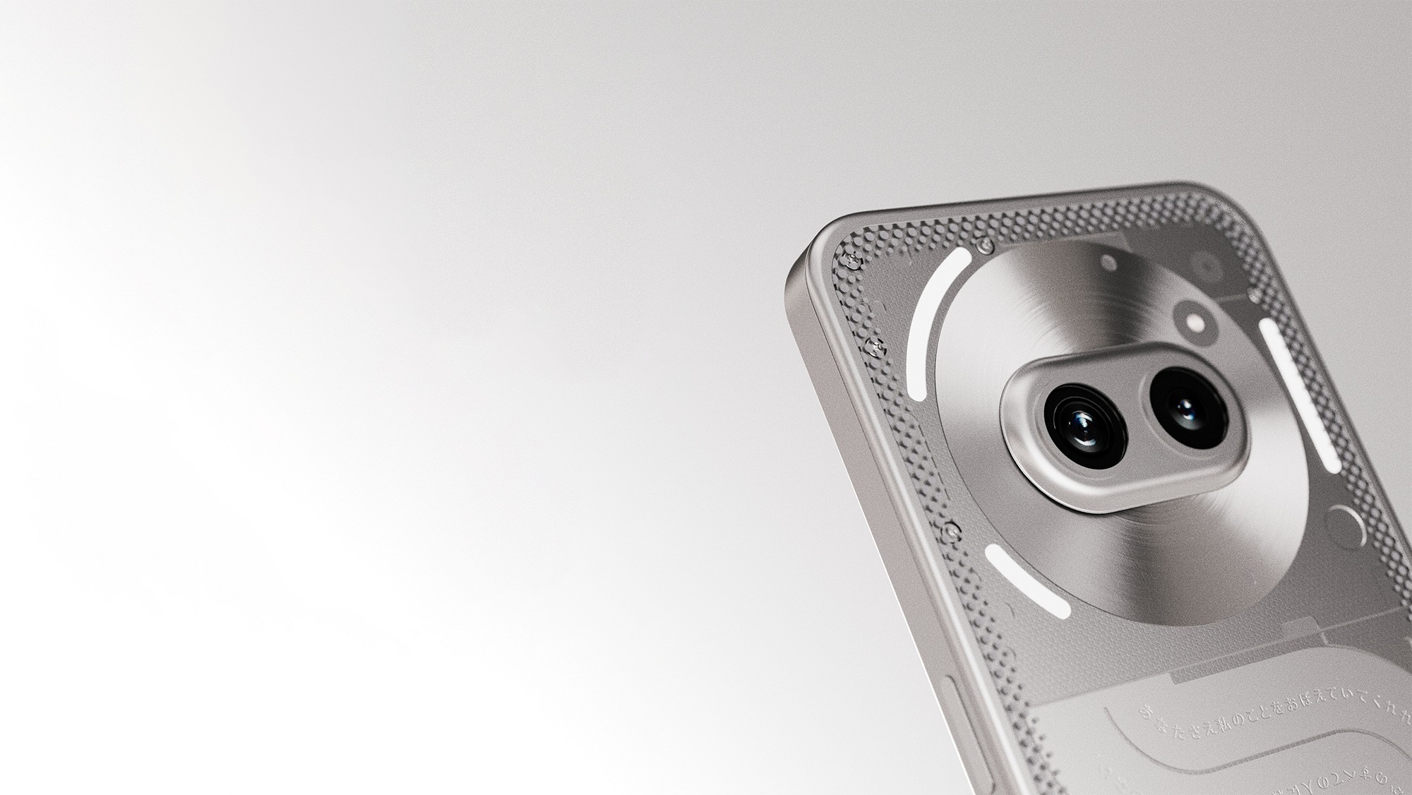Detail view of dual camera housing in raw aluminum frame with micro-textured chamfer