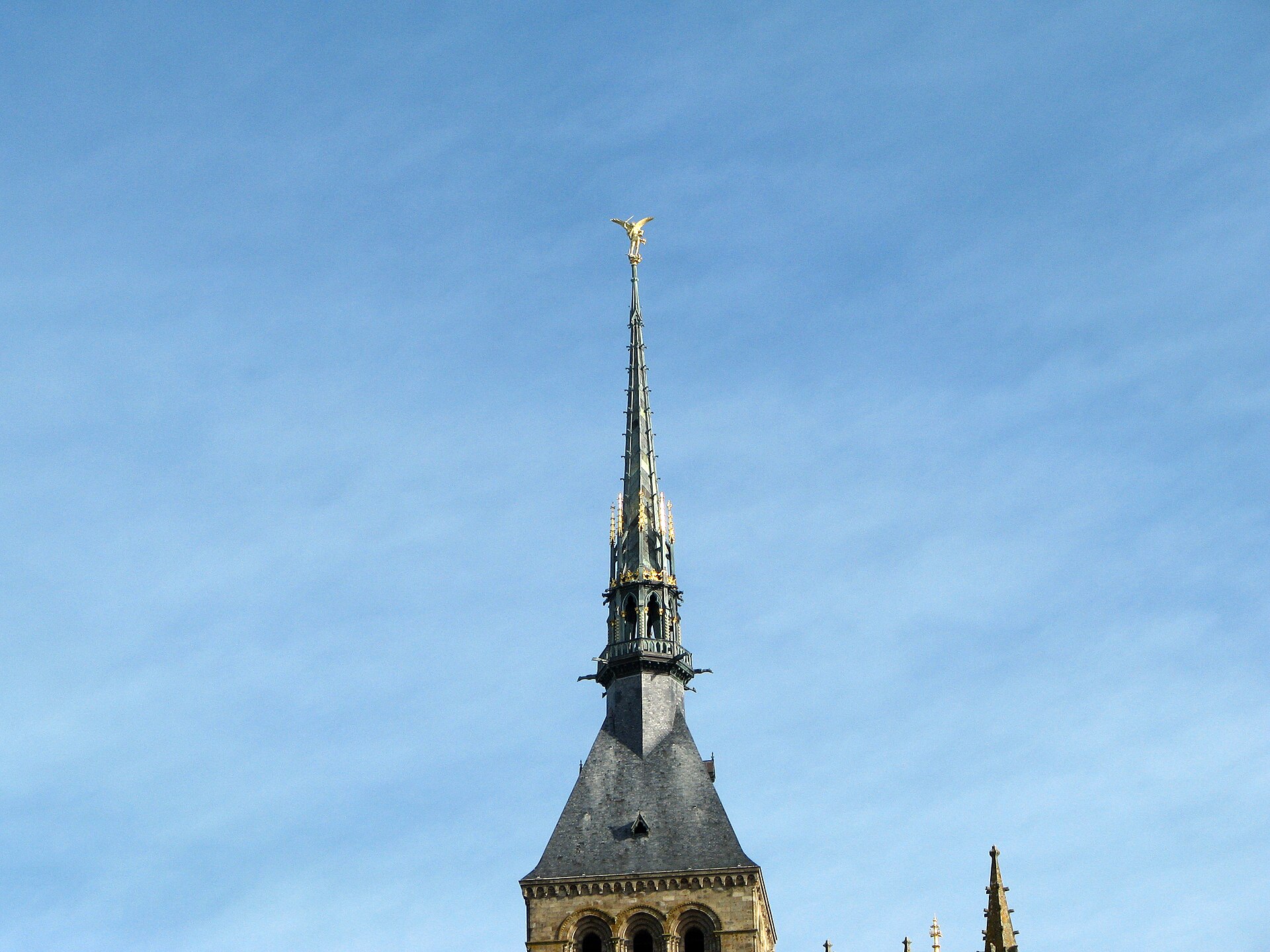 a group of people walking down a street next to trees