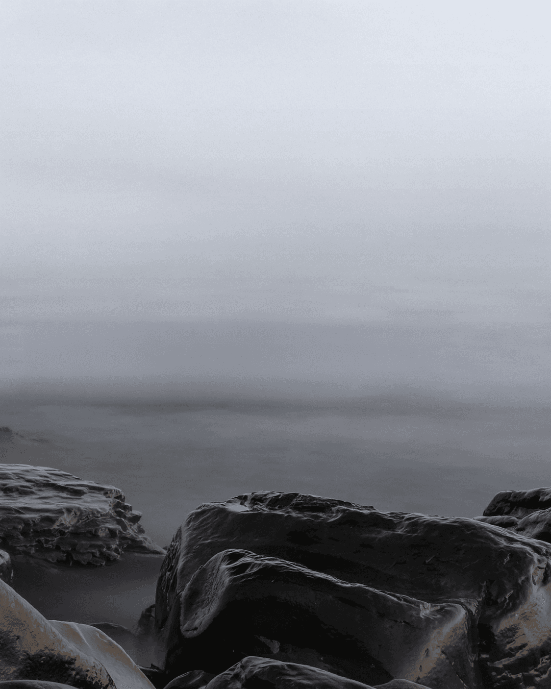 A modern gallery with paintings and skylights