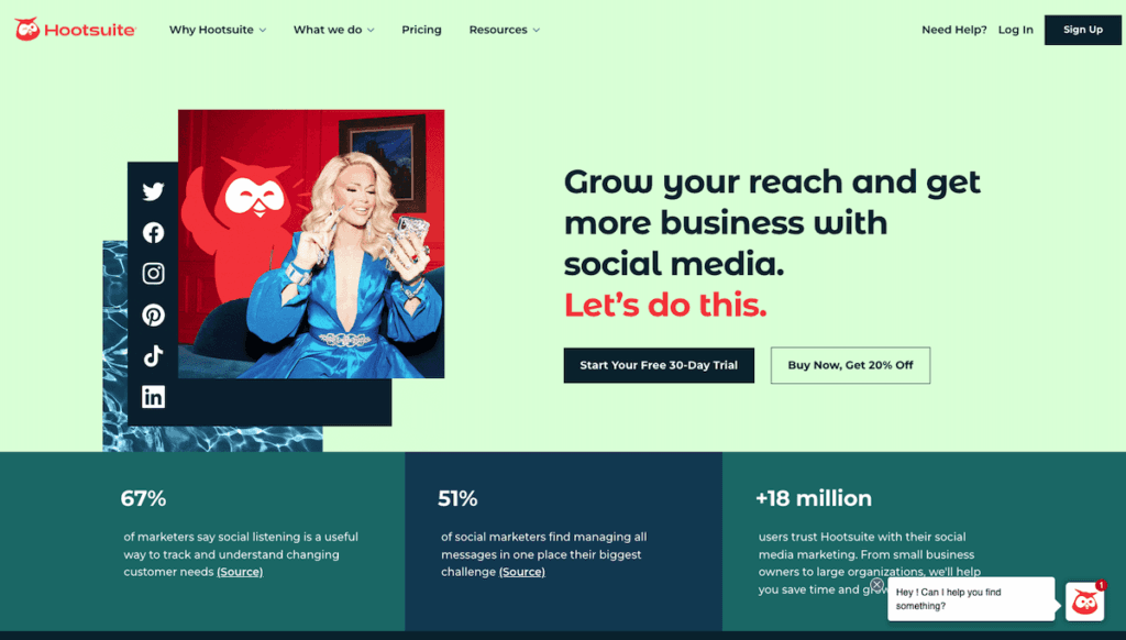 Hootsuite’s landing page in vibrant light and dark green background with the image of a woman on her phone