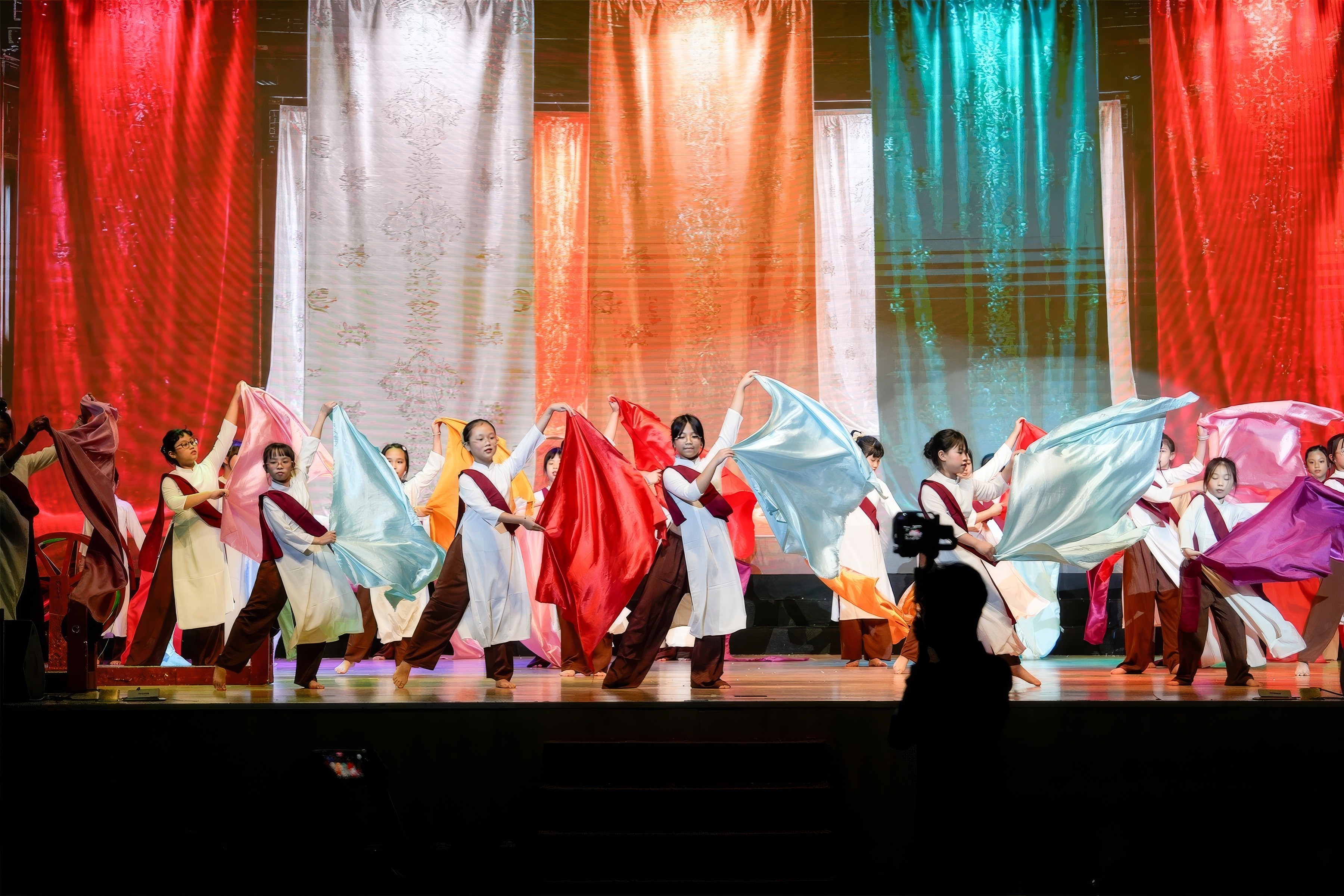 A close-up of a beige-colored laptop with a smooth, matte finish on a matching surface.