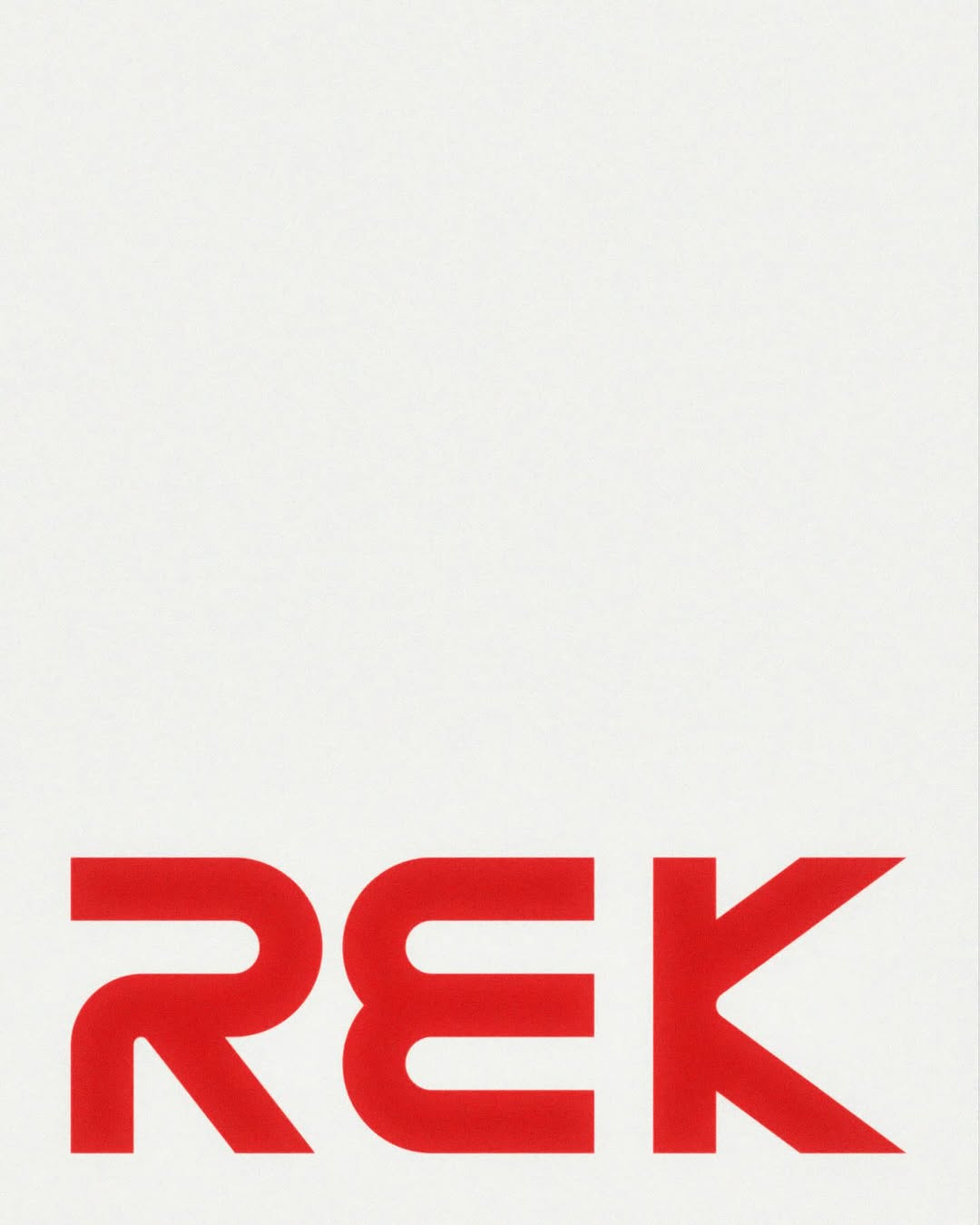 An arched stone building facade with windows.