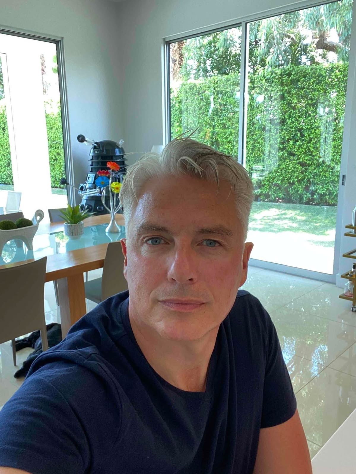 a man with a goatee smiles at the camera