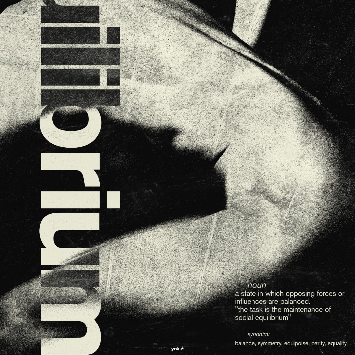 man wearing grey t-shirt standing in front of man sitting on chair