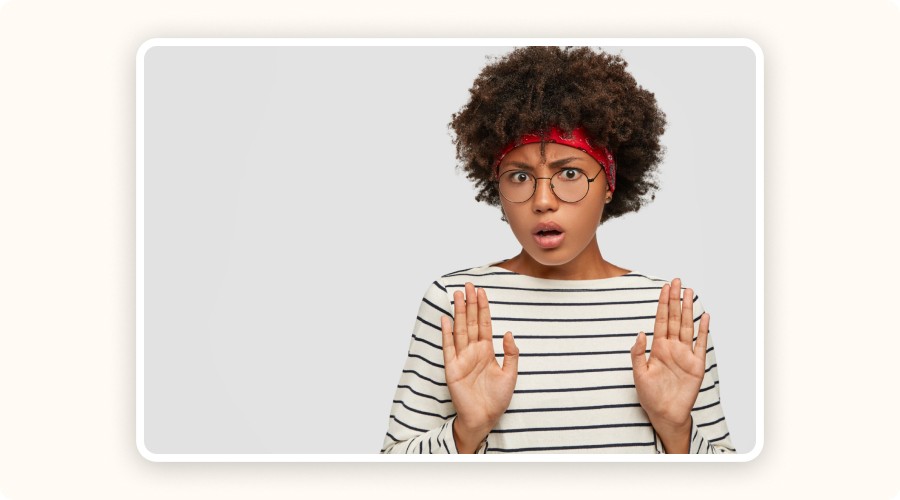 Surprised woman raising hands in stop gesture, reacting with shock or concern&nbsp;