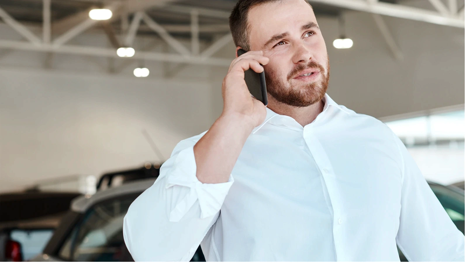 Phone call, talking or salesman in car dealership for vehicle, finance communication or networking. Trader, agent or seller in showroom speaking for business, transportation or advice by automobile