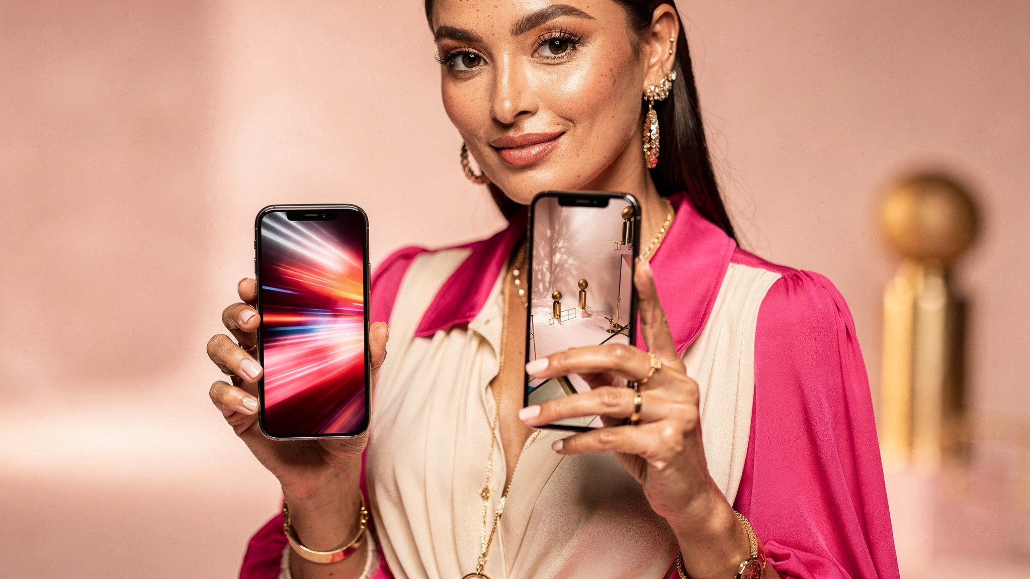 Adult woman creator holding two phones showing different vertical video clips