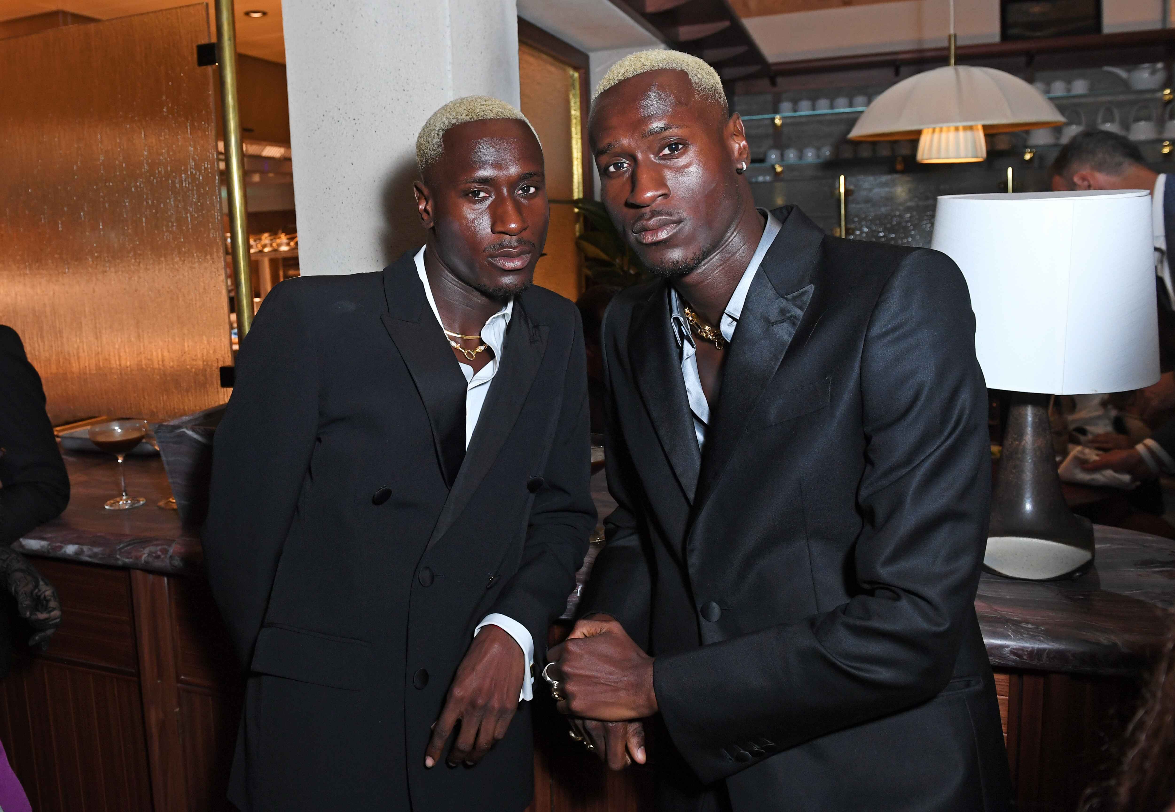 Woman in black outfit sitting on floor