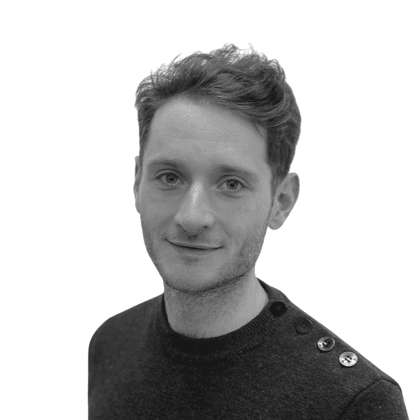 a man standing in front of a tree smiling