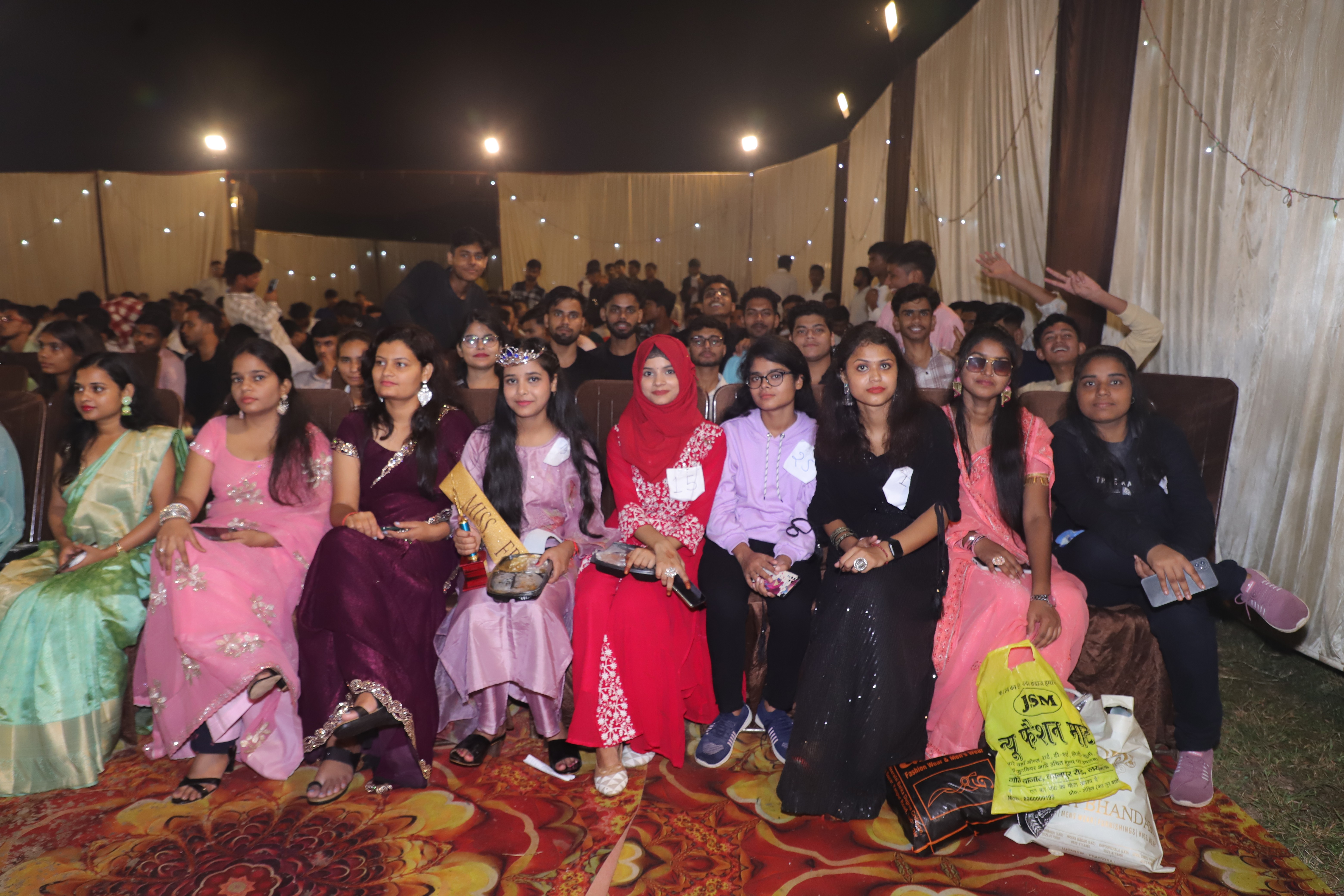 people sitting on chair in front of table while holding pens during daytime